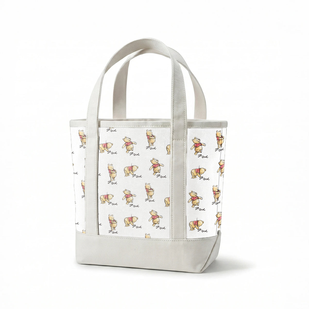 Winnie the Pooh pattern featuring cute yellow bears with red shirts in various poses, labeled "Pooh springs canvastote mockup