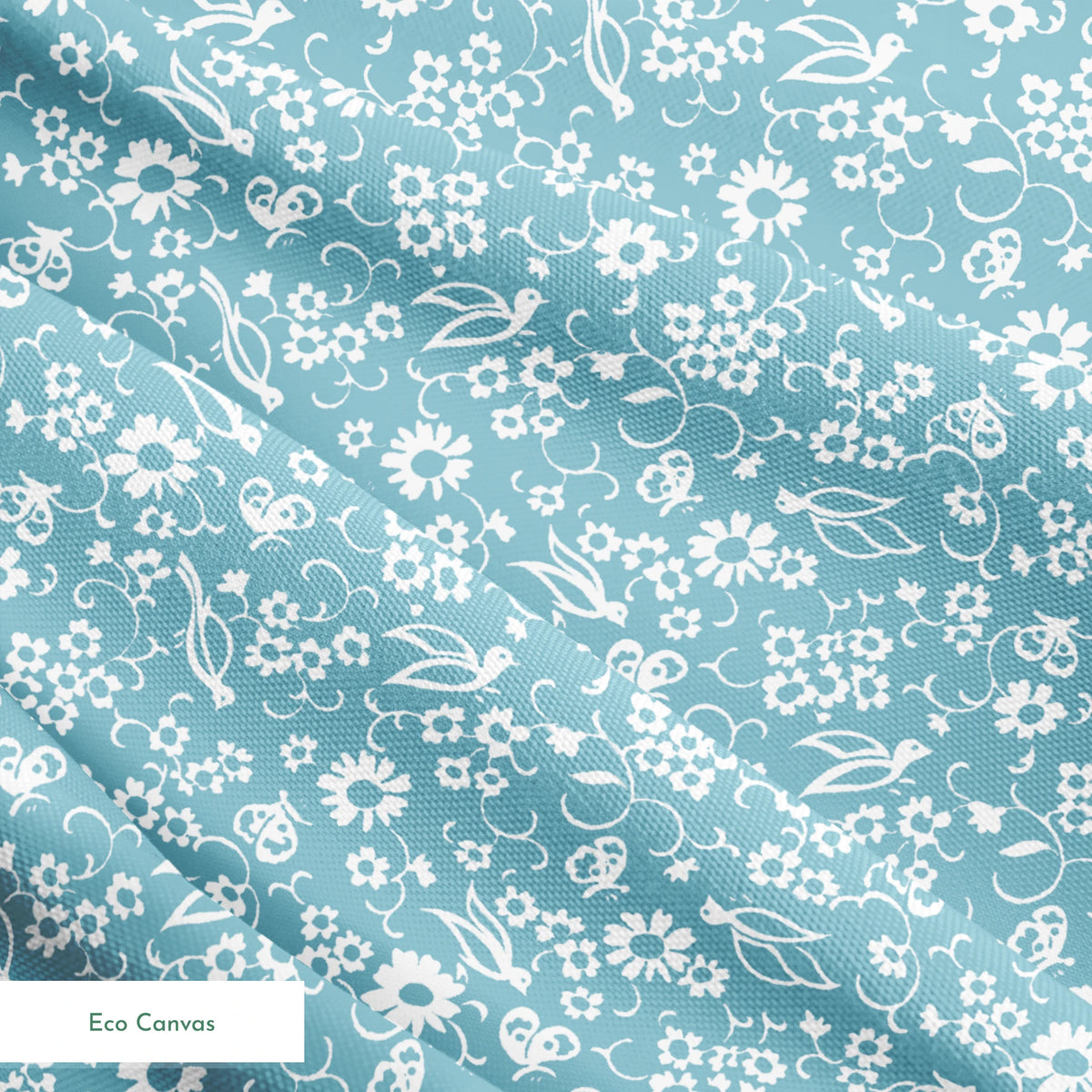 White vintage-style bird and floral silhouettes on a dusty blue background. springs ecocanvas texture