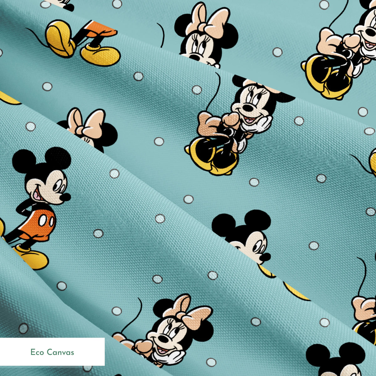 Cartoon pattern of Mickey and Minnie Mouse characters on light blue background with white dots springs ecocanvas texture
