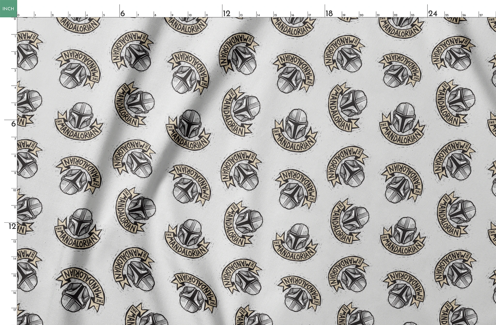 Star Wars Mandalorian helmet logo pattern with banners in black and gold on light background springs fatquarter mockup