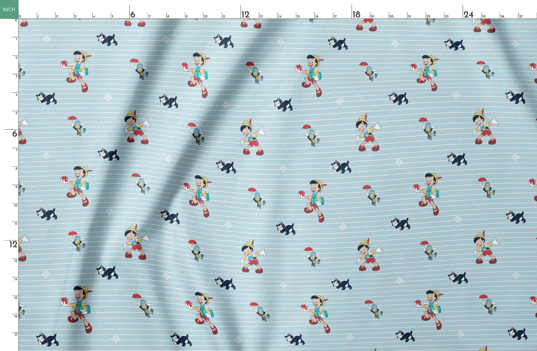 Cartoon pattern with boy character holding apple, black kittens, snowflakes on light blue striped background springs fatquarter mockup