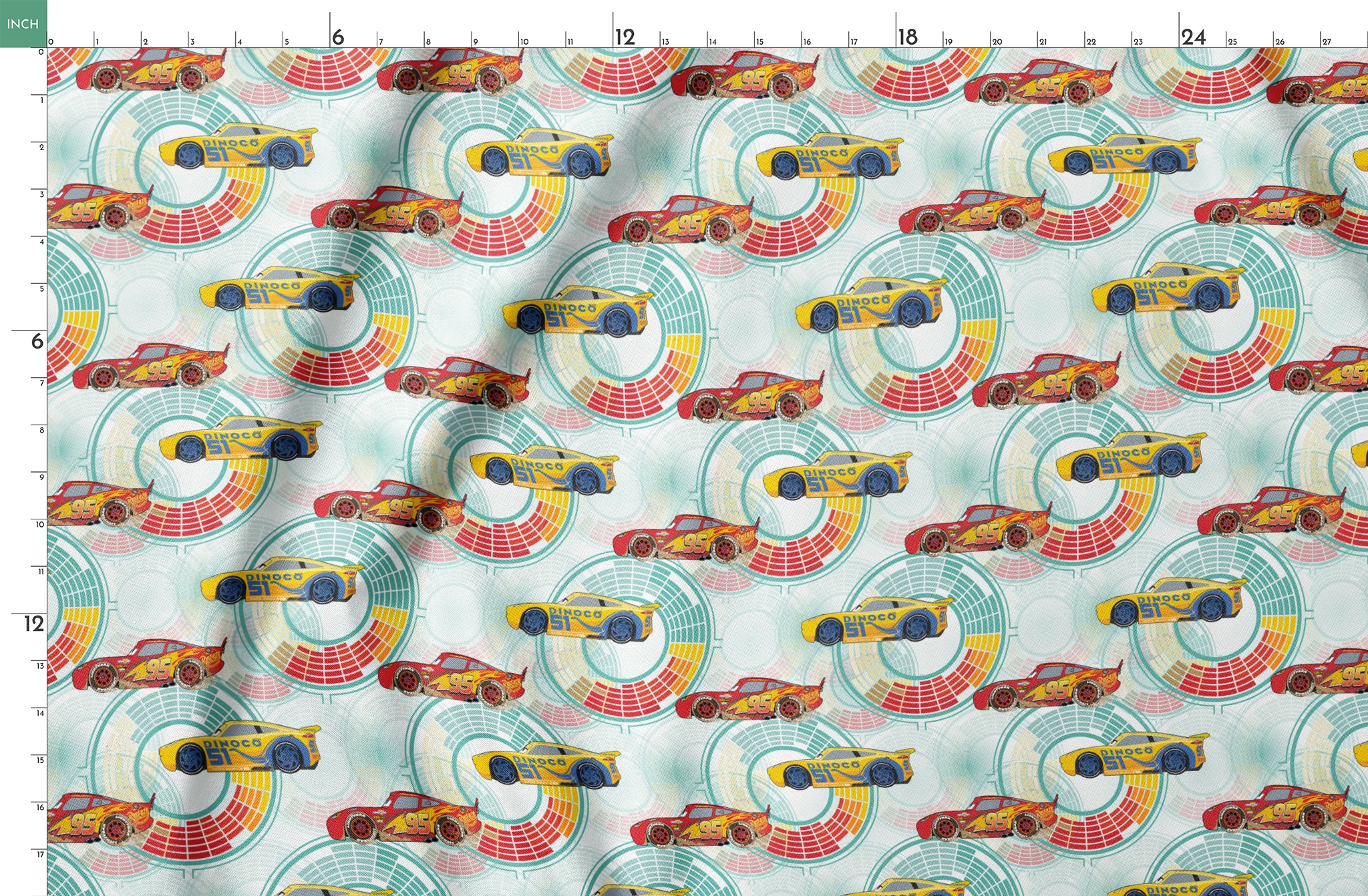 Colorful Disney Pixar Cars racing in red and yellow on a light blue background with circular patterns springs fatquarter mockup