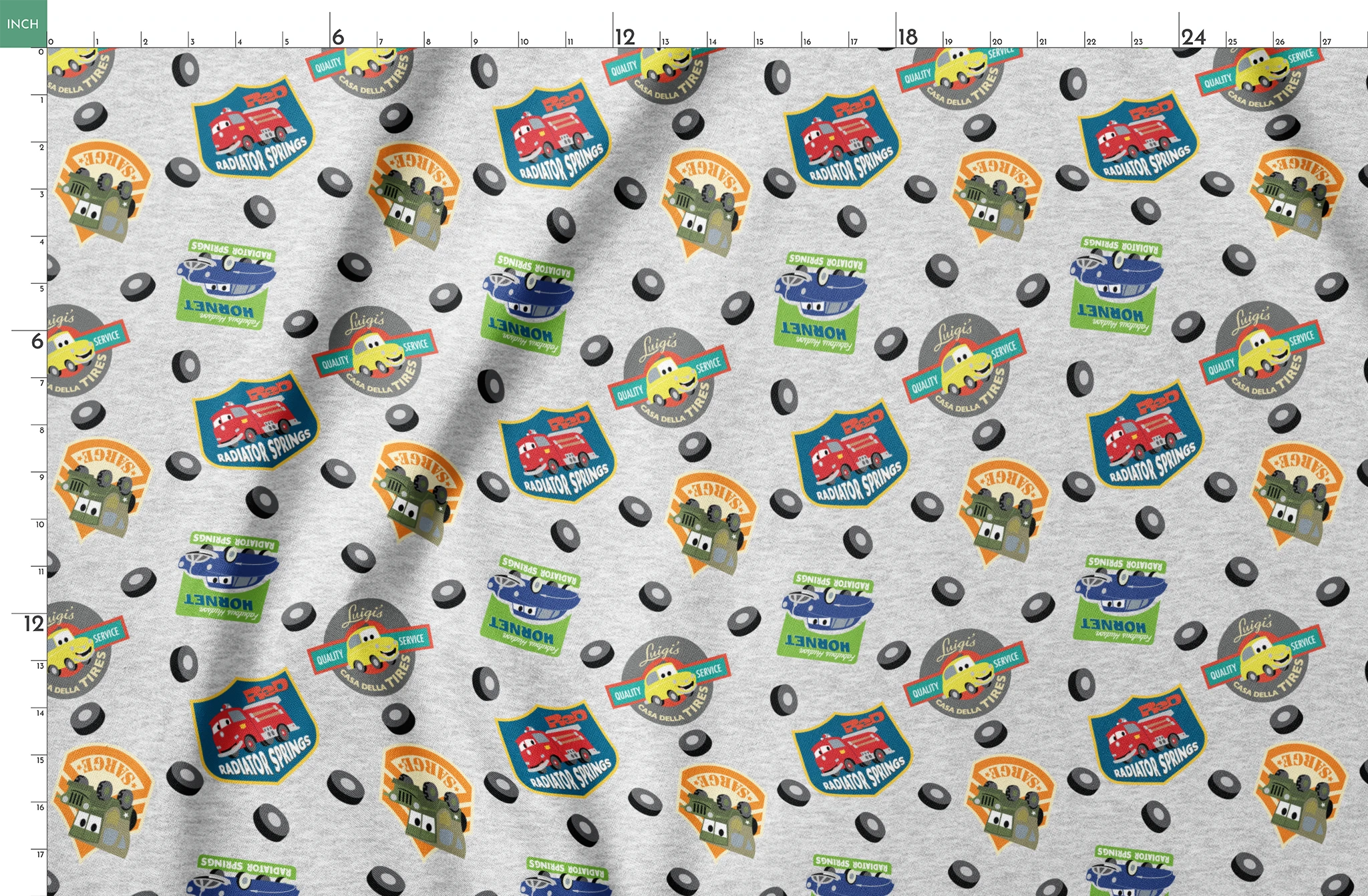 Cartoon vehicle characters on gray fabric with badges for Radiator Springs, Luigi's, and Sarge's springs fatquarter mockup