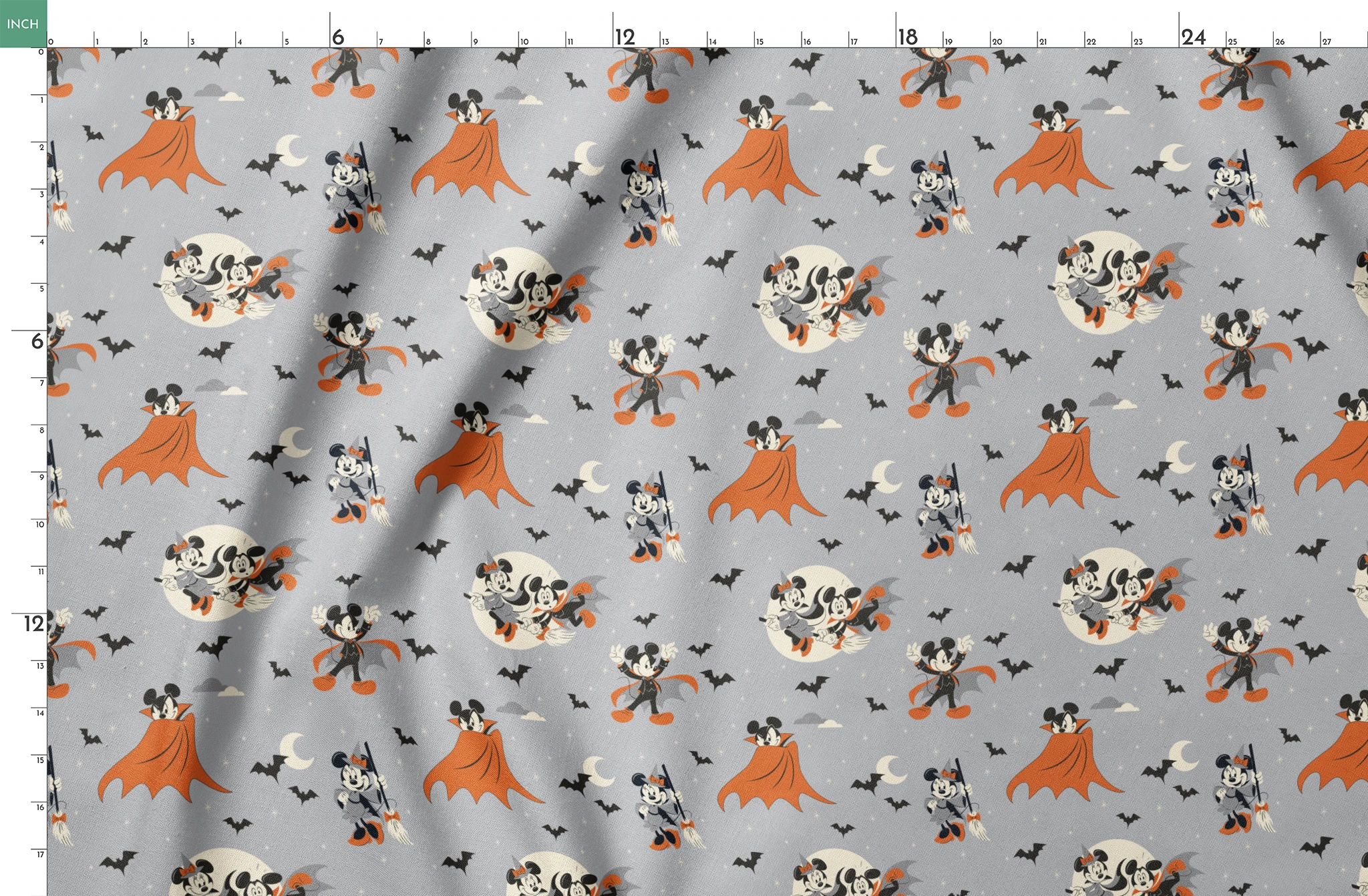 Mickey and Minnie Mouse in Halloween costumes on gray background with bats and moons, orange capes and spooky theme. springs fatquarter mockup