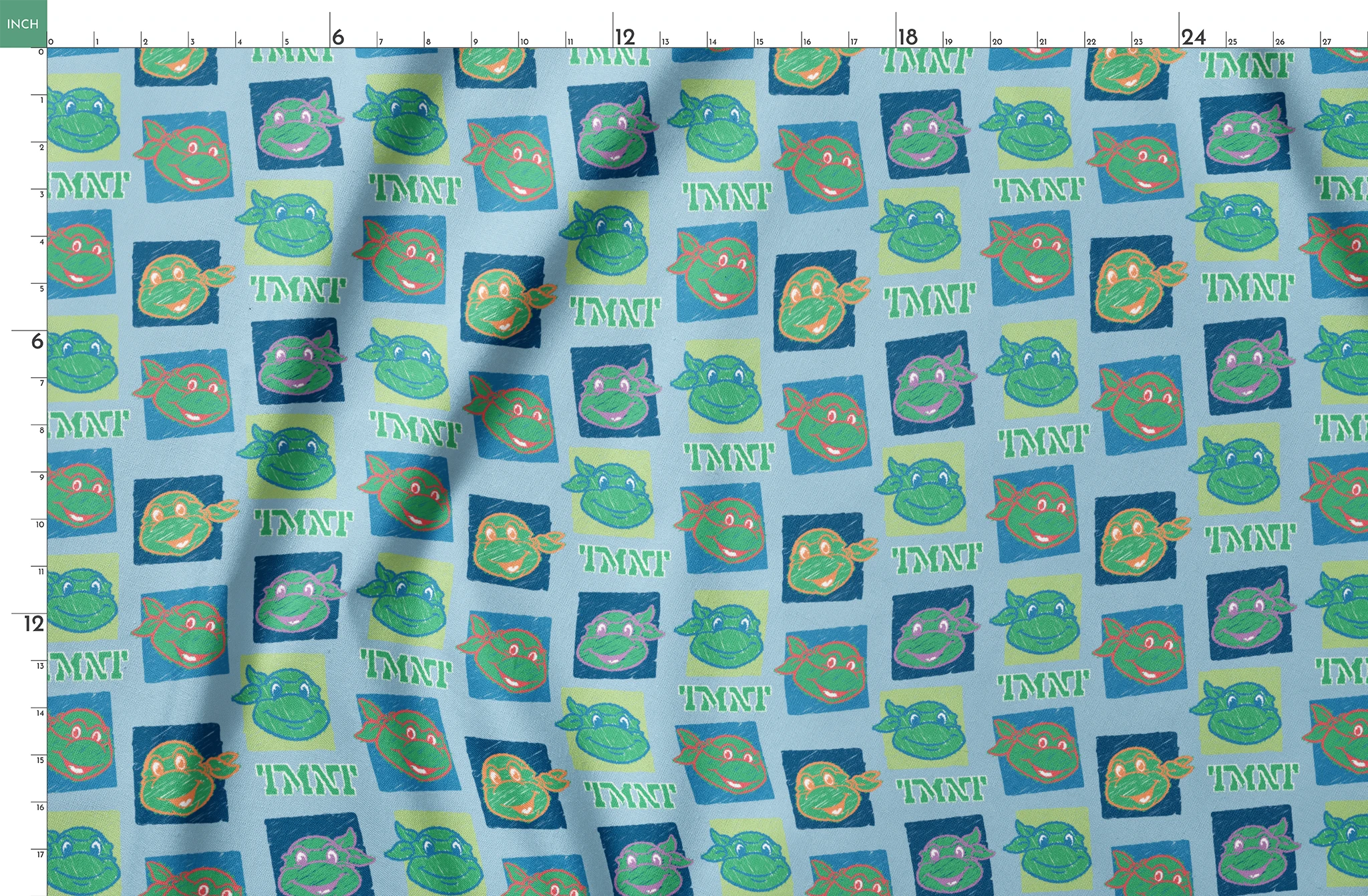 Teenage Mutant Ninja Turtles pattern with cartoon turtle faces in squares on light blue background springs fatquarter mockup