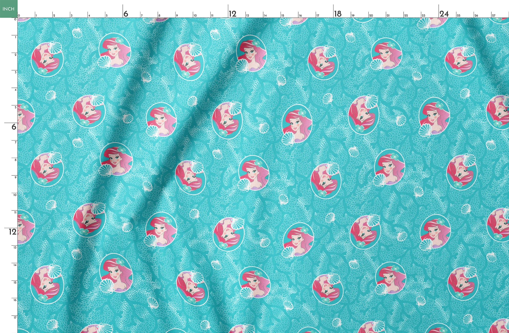 The Little Mermaid pattern with Ariel in turquoise circles on aqua background with seashells springs fatquarter mockup