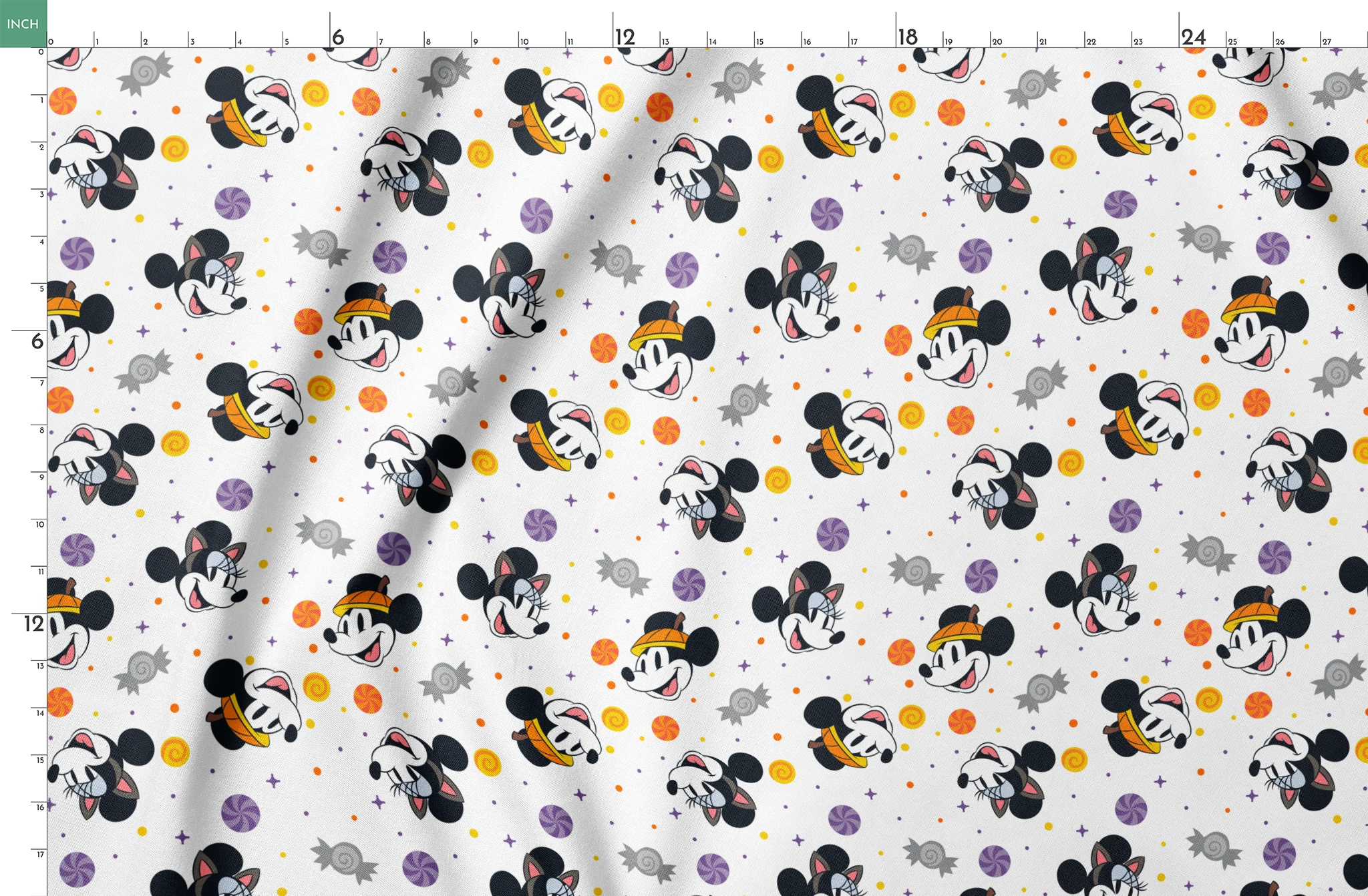 Mickey and Minnie Mouse cartoon heads scattered with wrapped candies and colorful dots on white background springs fatquarter mockup