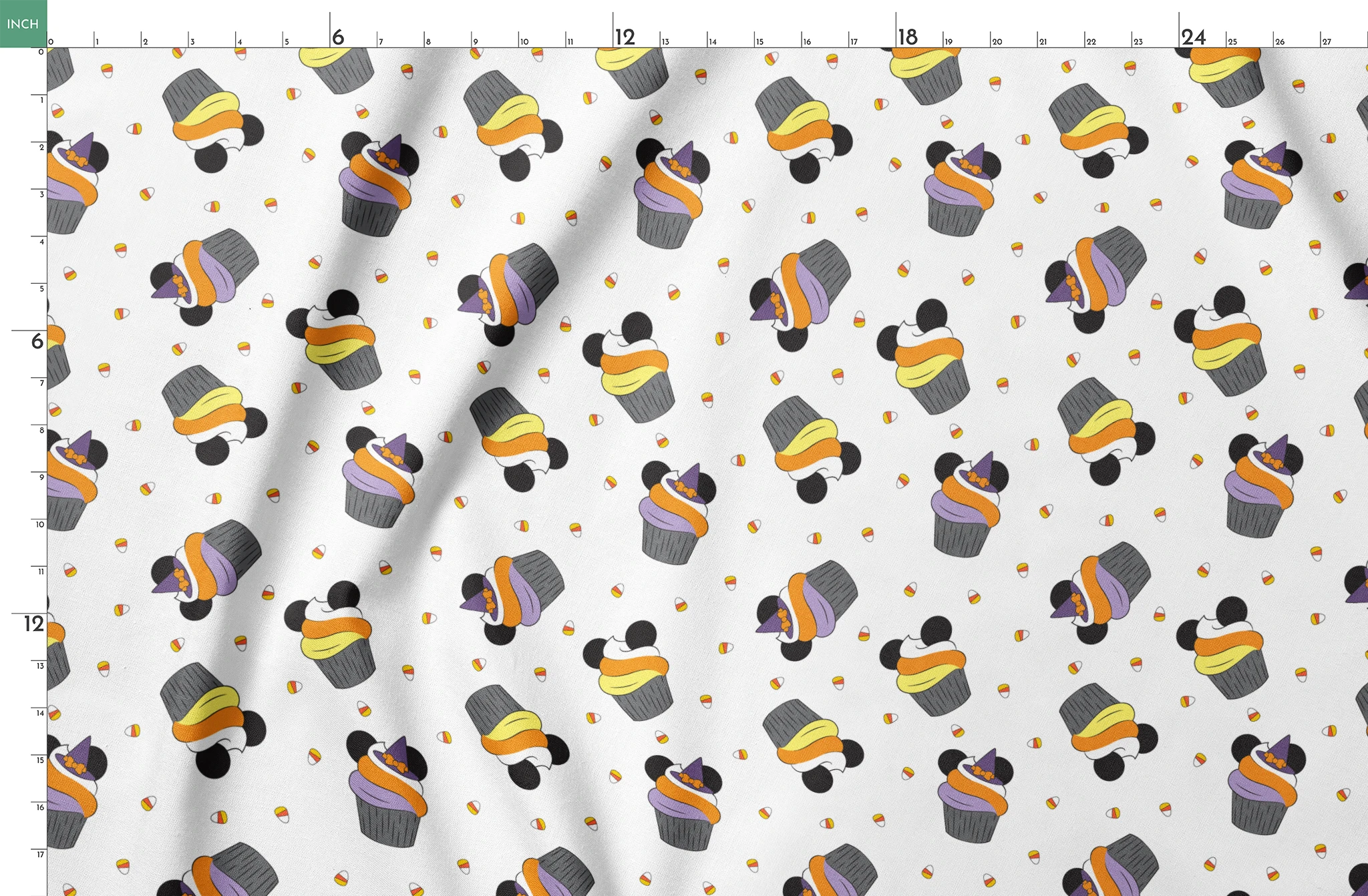 Disney cupcakes with black circular elements and colorful frosting in orange, yellow, and purple on a white background. springs fatquarter mockup