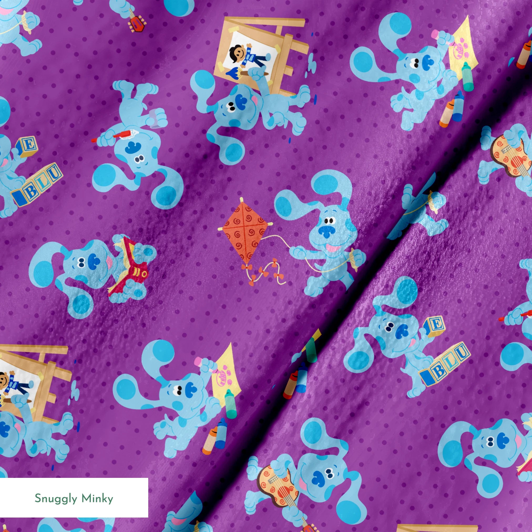 Blue cartoon dog characters on purple polka dot background with toys and alphabet blocks pattern springs minky texture
