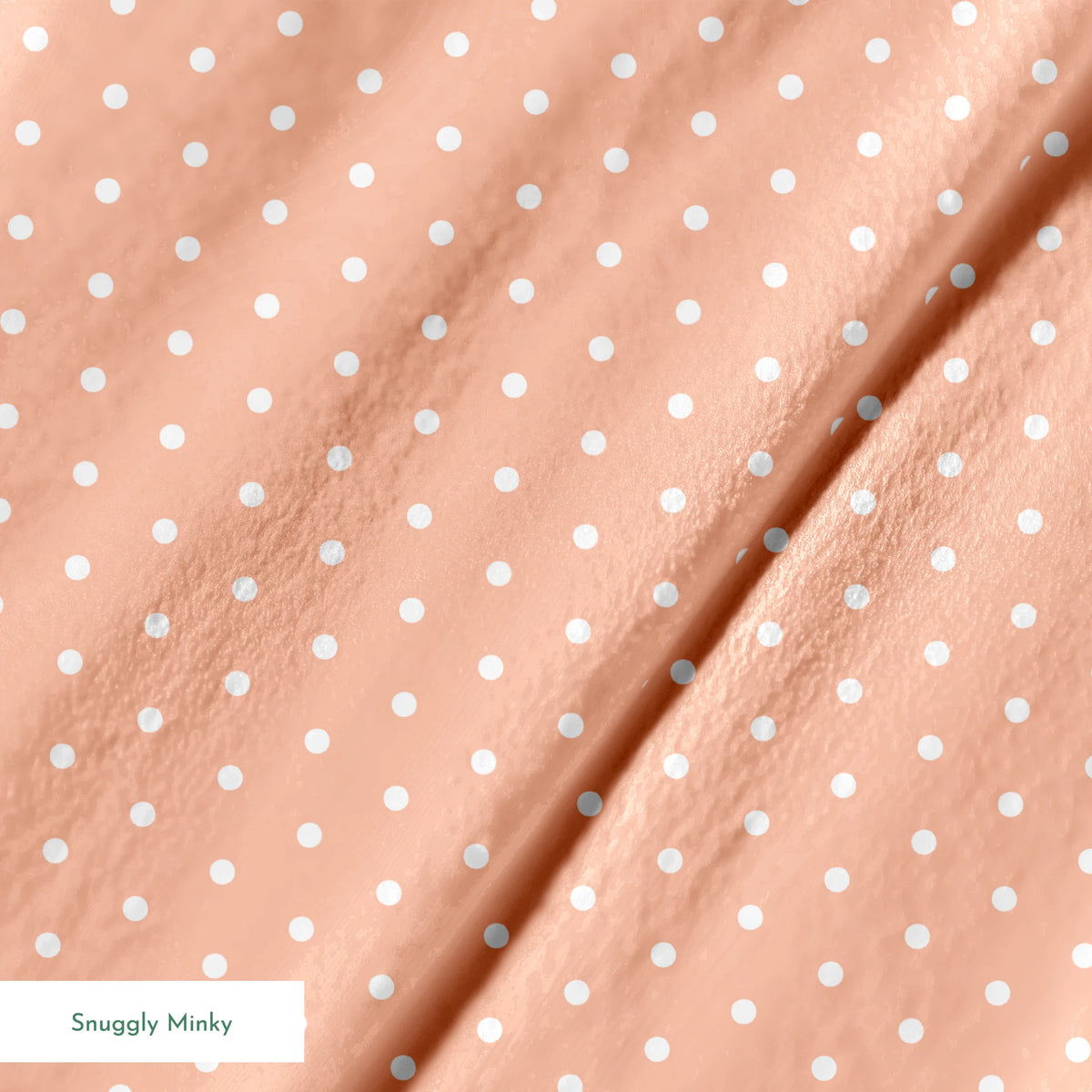 White circles on a peach/salmon colored background springs minky texture