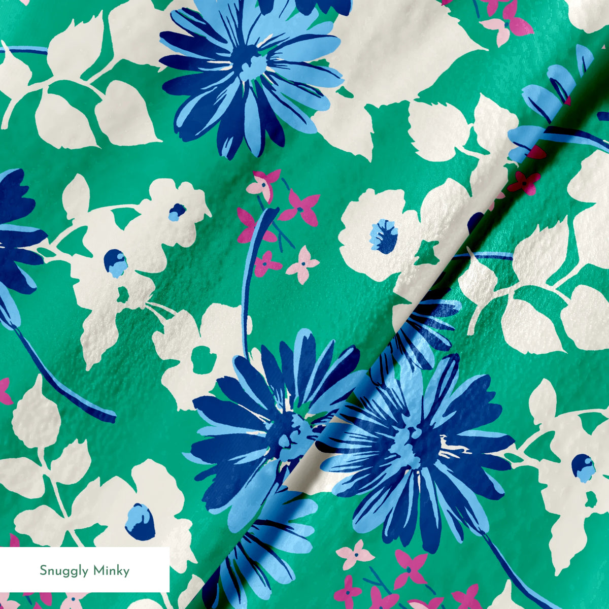 Vibrant floral pattern with blue spiky flowers and white blooms on a green background springs minky texture
