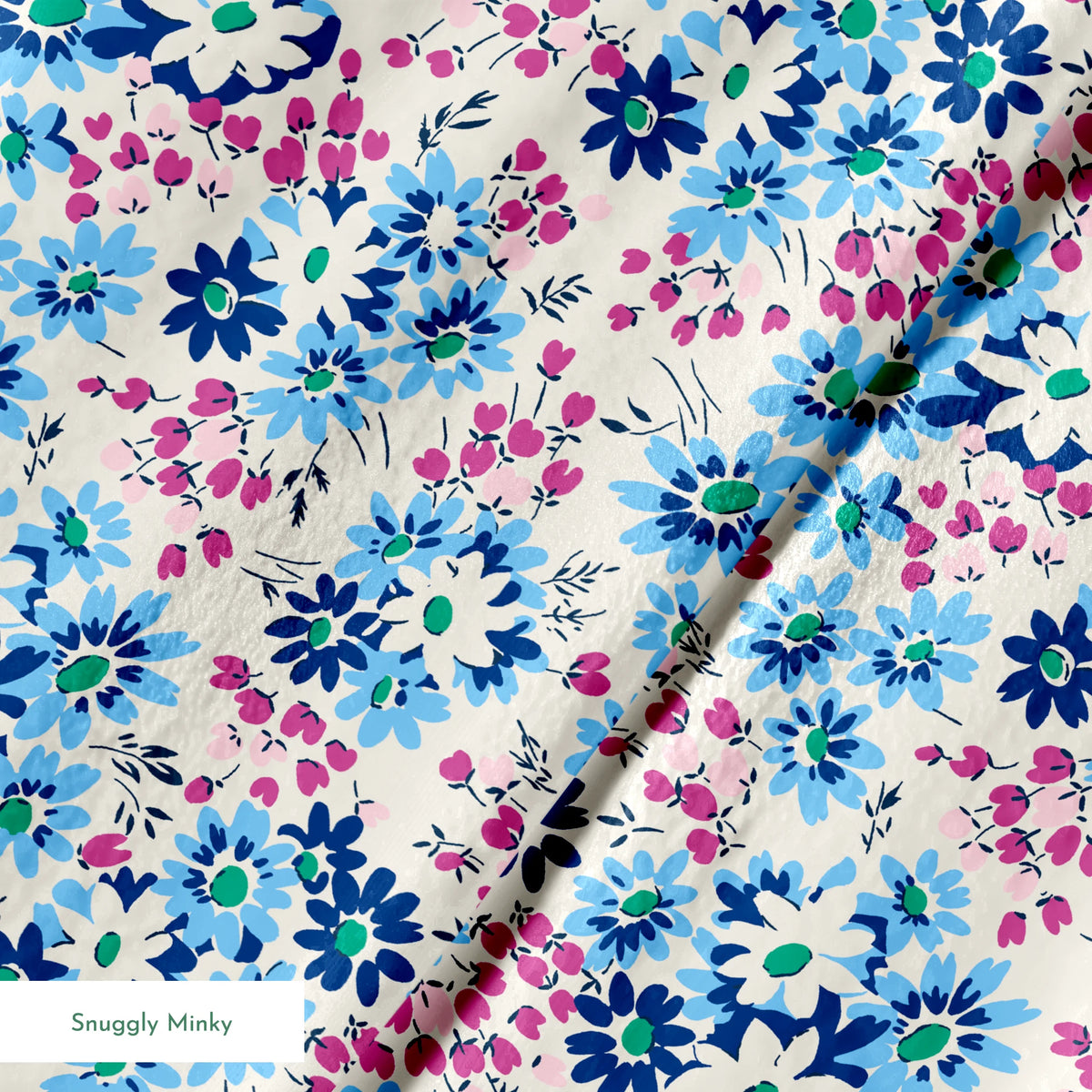 Floral pattern with blue, navy, and white daisies alongside small magenta berries on cream background springs minky texture