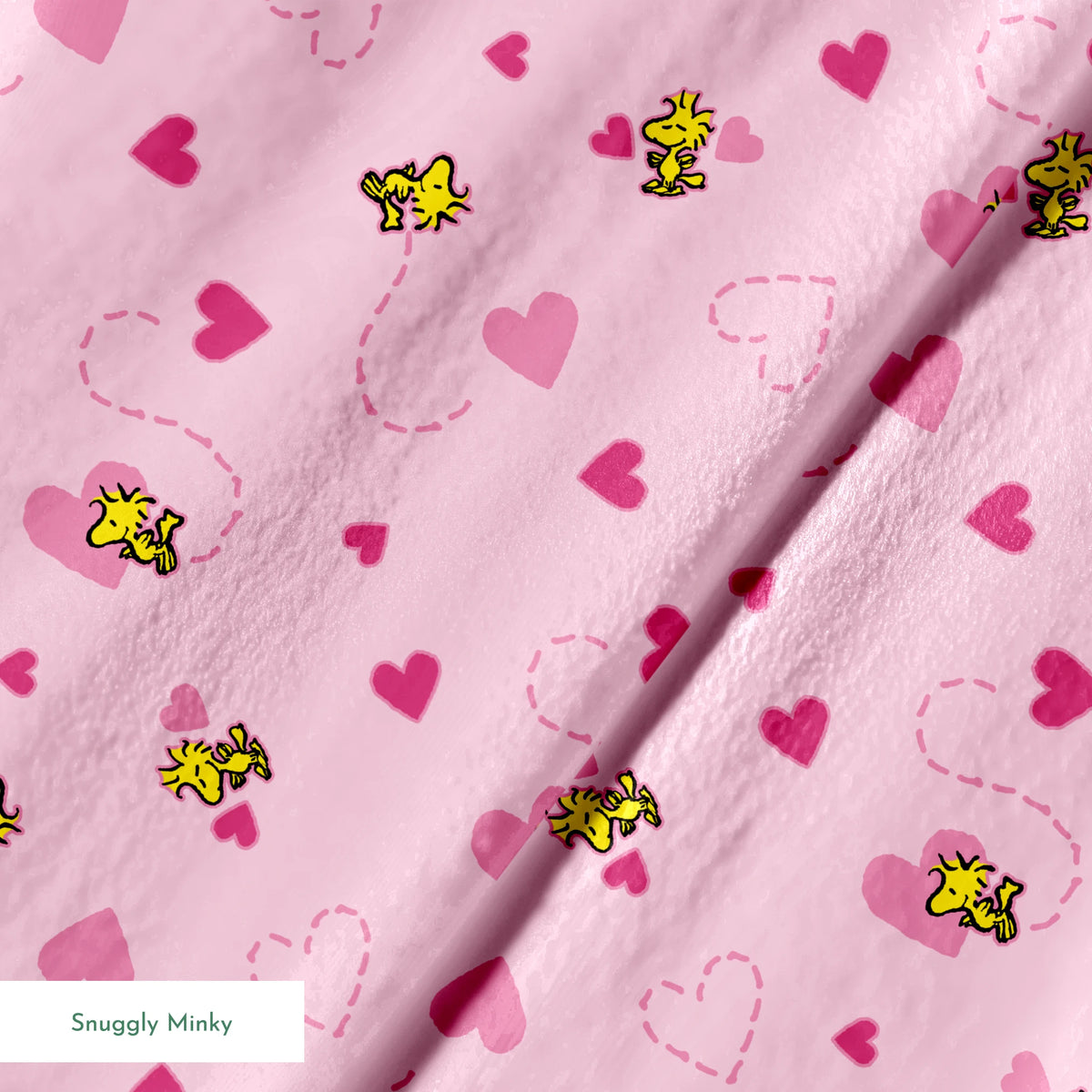 Pink background with hearts and Woodstock pattern, dotted heart outlines and solid pink hearts scattered throughout. springs minky texture