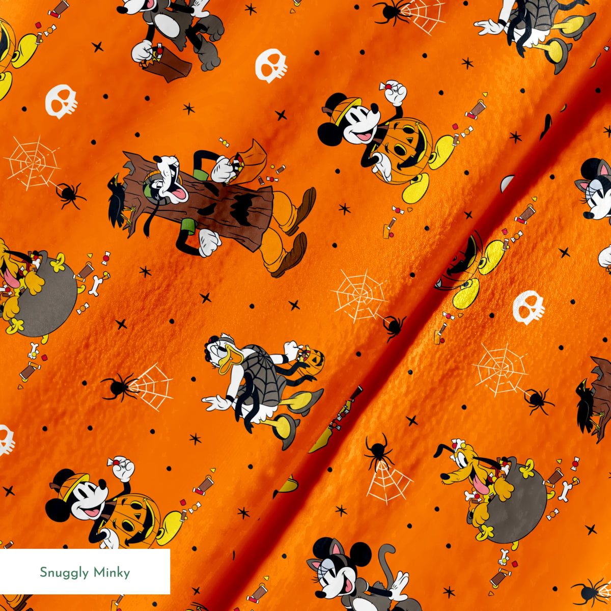 Halloween-themed orange pattern with Disney characters in costumes, spiderwebs, and skulls springs minky texture