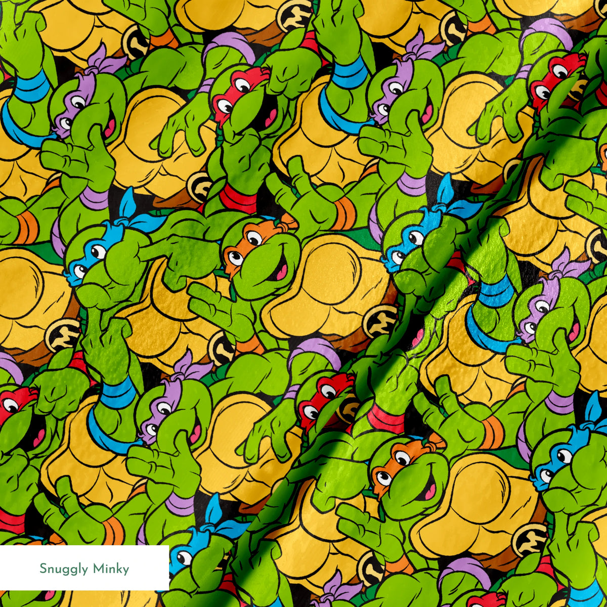 Colorful pattern of cartoon Teenage Mutant Ninja Turtles with green skin and yellow shells springs minky texture