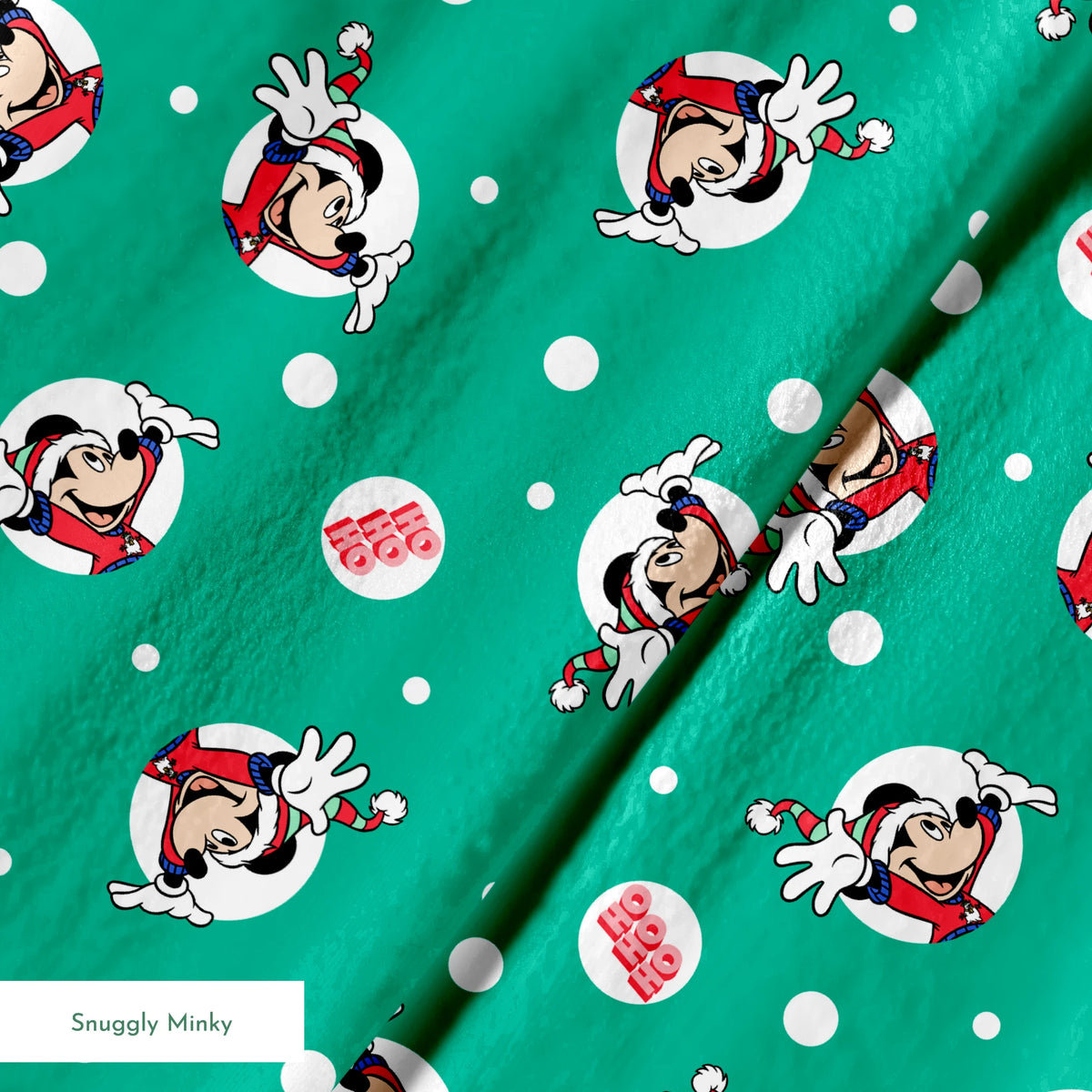 Mickey Mouse in Santa hats on green polka dot background with "Ho Ho Ho" text springs minky texture