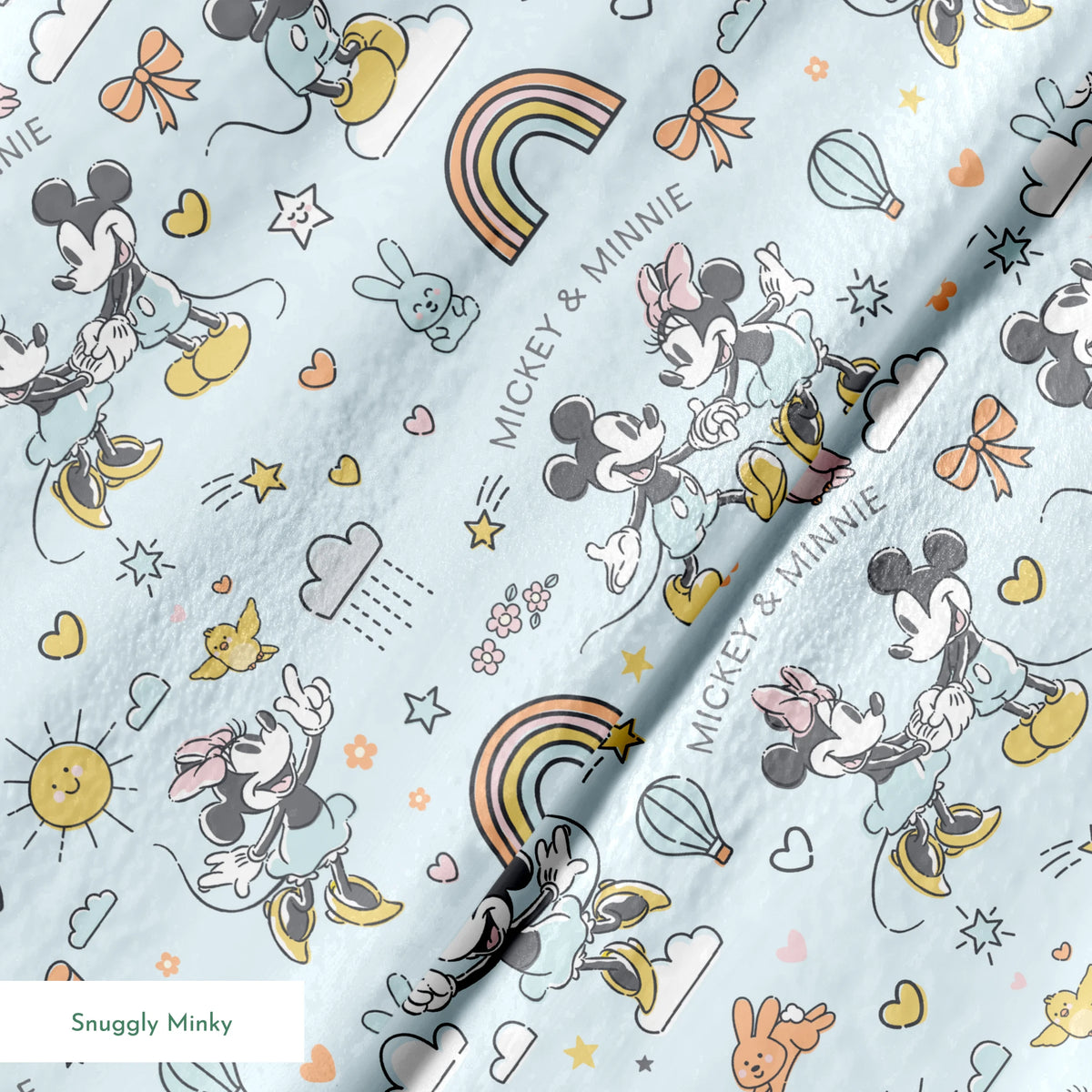 Playful Disney pattern with classic cartoon characters, rainbows, hearts, and whimsical elements on light blue background. springs minky texture