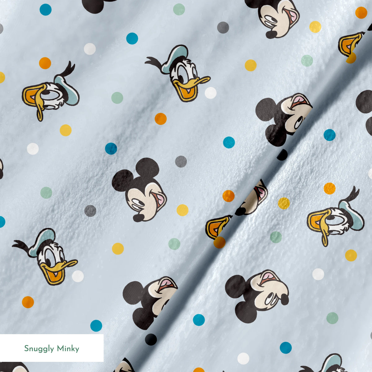 Disney character pattern with Mickey Mouse and Donald Duck heads scattered on light blue background with colorful polka dots springs minky texture