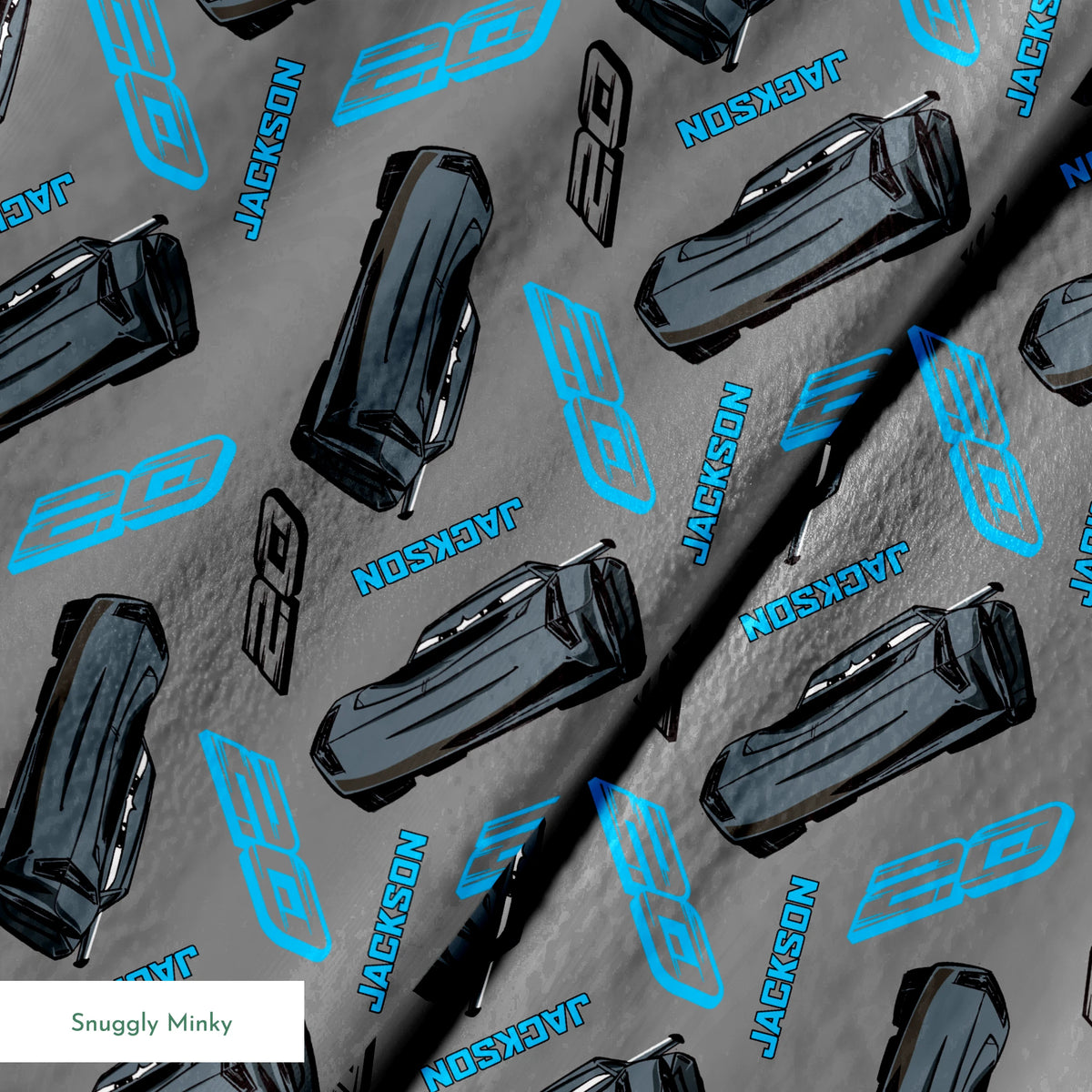 Dark gray background with scattered black car parts and blue "JACKSON" text and stylized logos in a repeating pattern springs minky texture