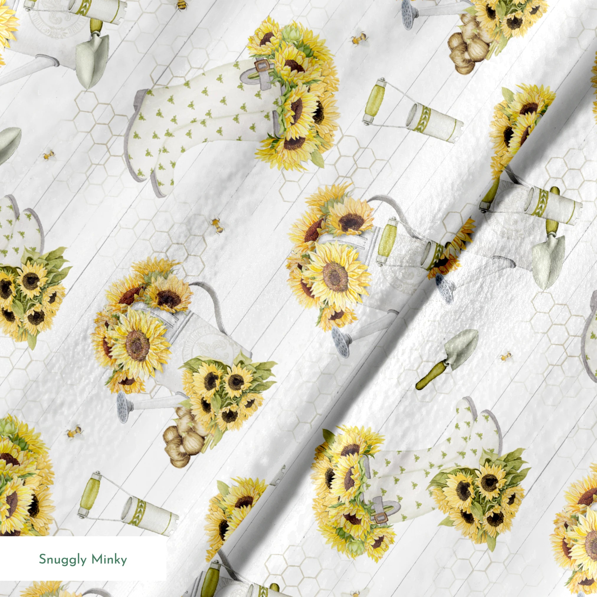 Sunflower-filled watering cans with bees, trowels, and garden tools on a white shiplap and honeycomb background. Designed by Nicole Tamarin. springs minky texture