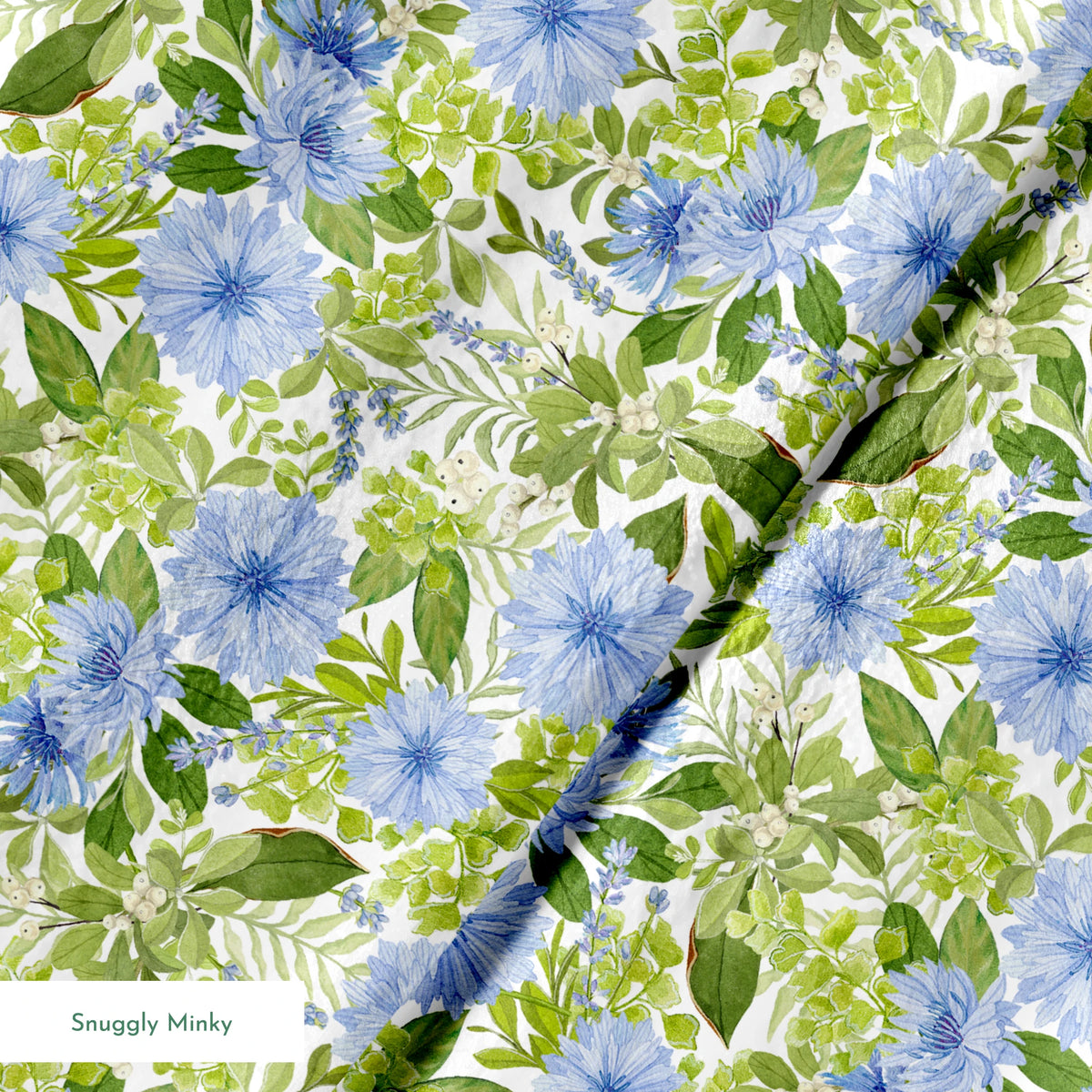 Watercolor-style botanical fabric pattern featuring blue wildflowers and soft green foliage on a white background. Designed by Nicole Tamarin. springs minky texture