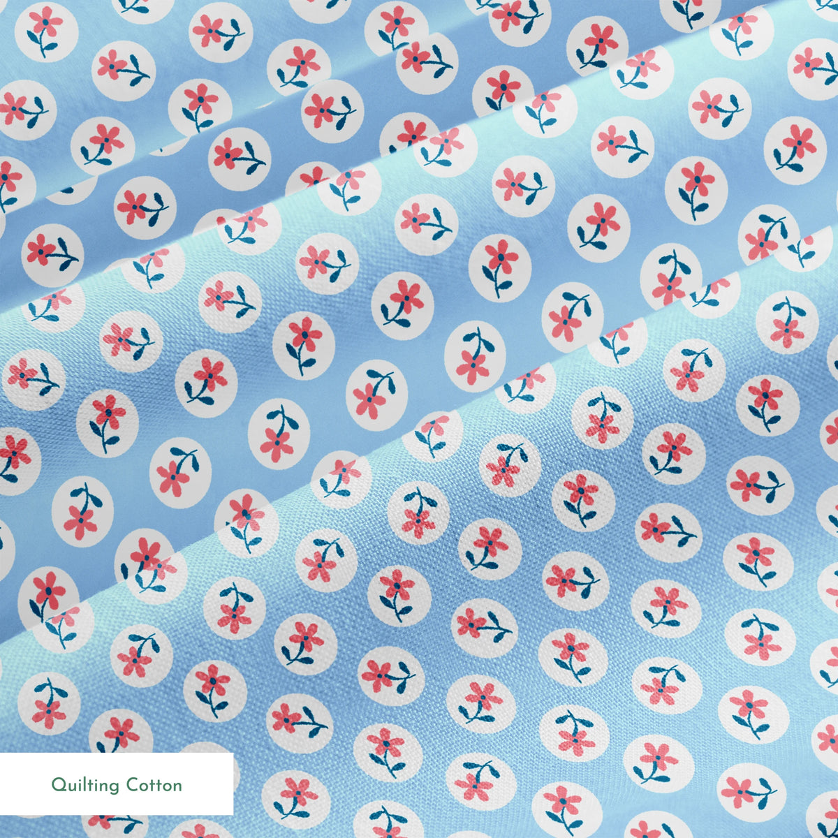 Pink flowers with blue-green stems in white circles on pale blue background, repeating pattern springs quiltingcotton texture
