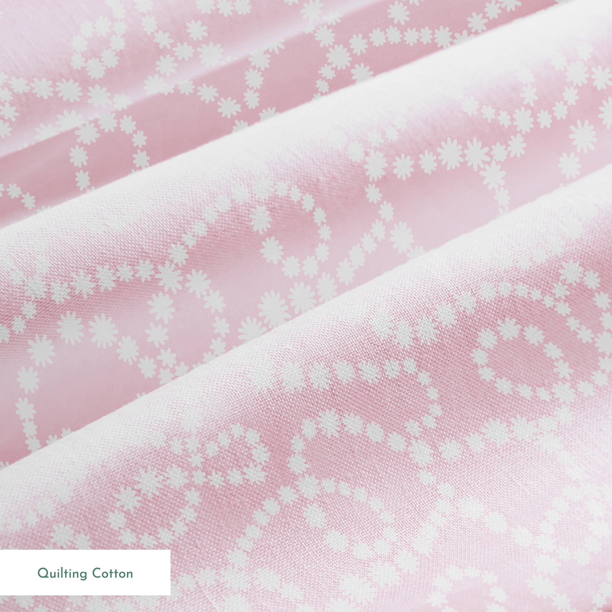 Baby pink background with white dotted swirling pattern creating delicate curved lines and loops springs quiltingcotton texture