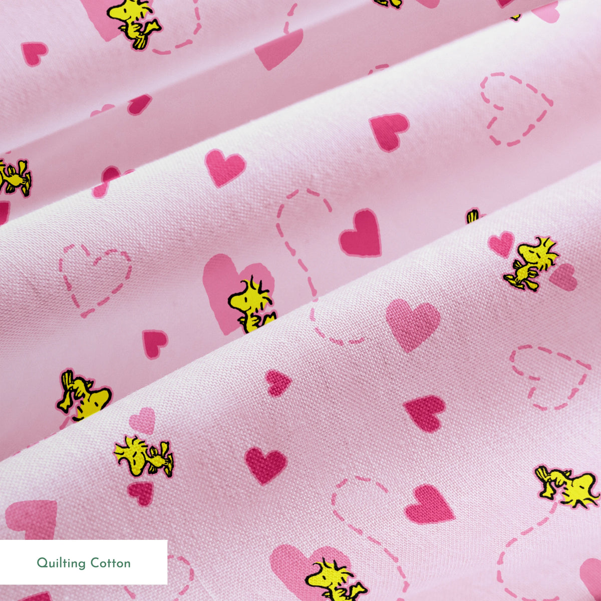 Pink background with hearts and Woodstock pattern, dotted heart outlines and solid pink hearts scattered throughout. springs quiltingcotton texture