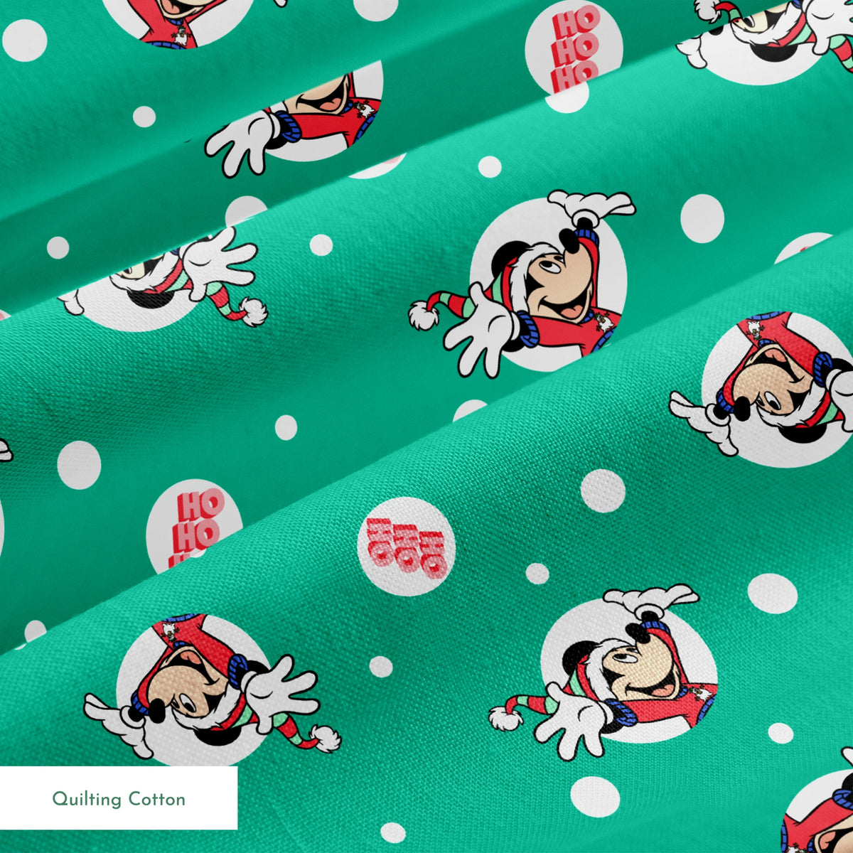 Mickey Mouse in Santa hats on green polka dot background with "Ho Ho Ho" text springs quiltingcotton texture