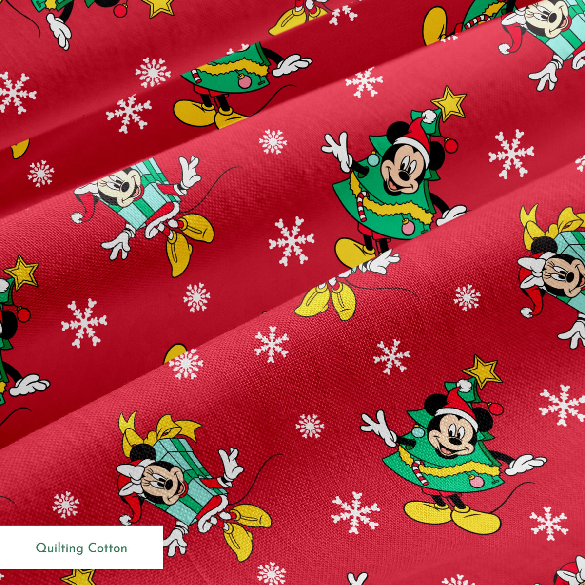 Disney characters in holiday outfits on red background with white snowflakes springs quiltingcotton texture