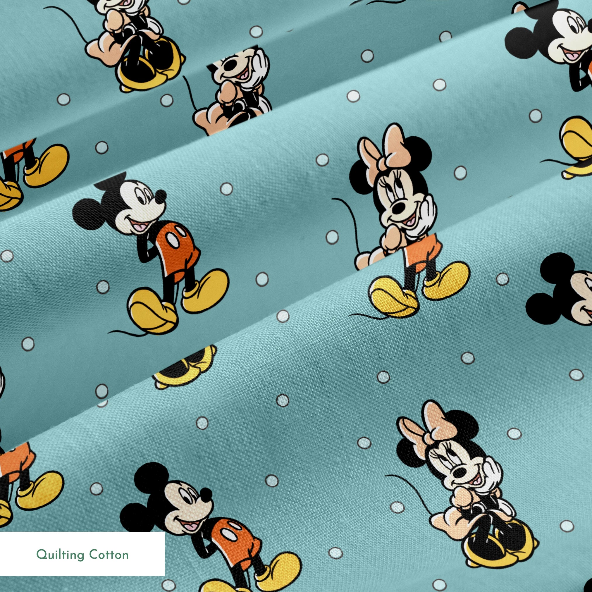 Cartoon pattern of Mickey and Minnie Mouse characters on light blue background with white dots springs quiltingcotton texture