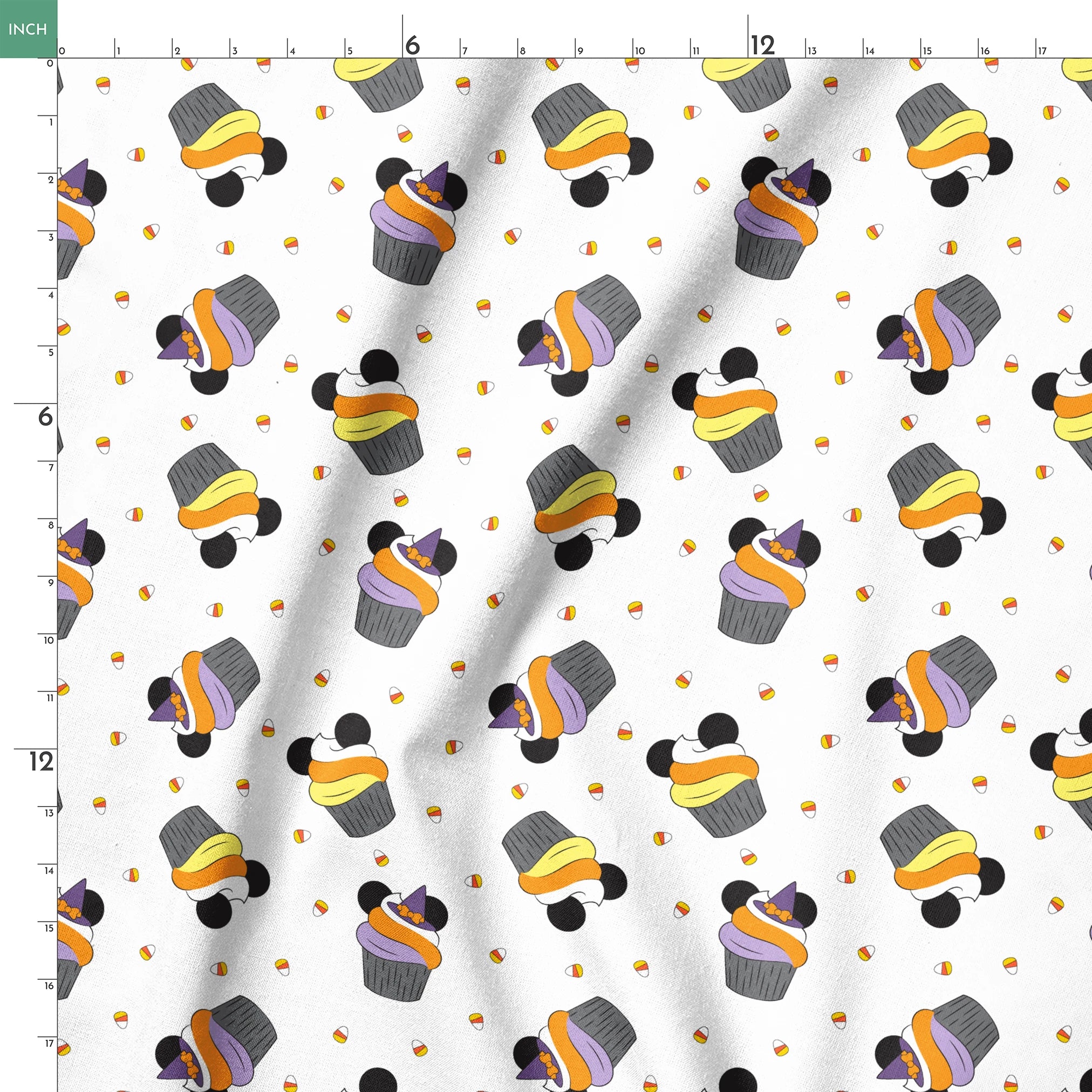 Disney cupcakes with black circular elements and colorful frosting in orange, yellow, and purple on a white background. springs ruler 18x18