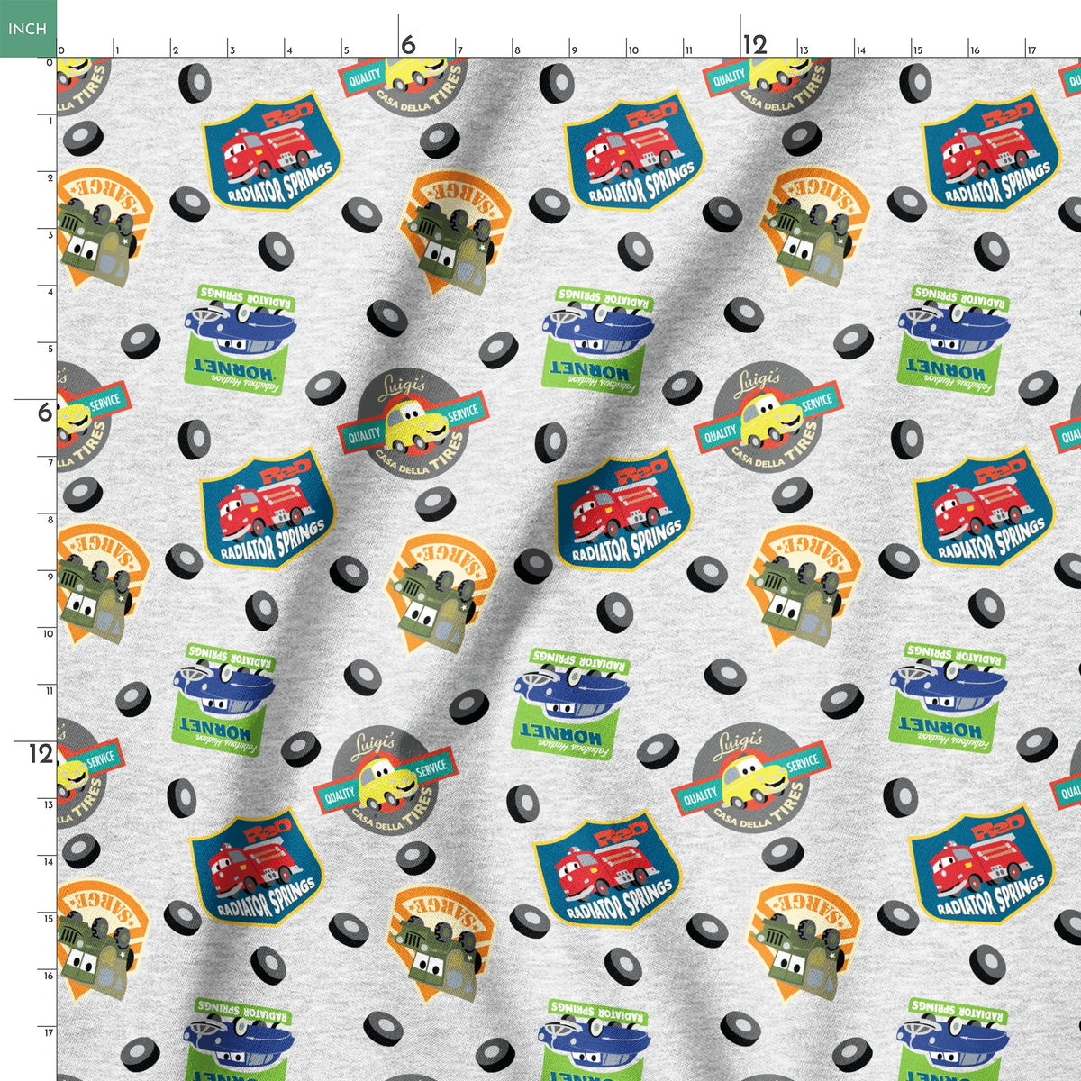 Cartoon vehicle characters on gray fabric with badges for Radiator Springs, Luigi's, and Sarge's springs ruler 18x18