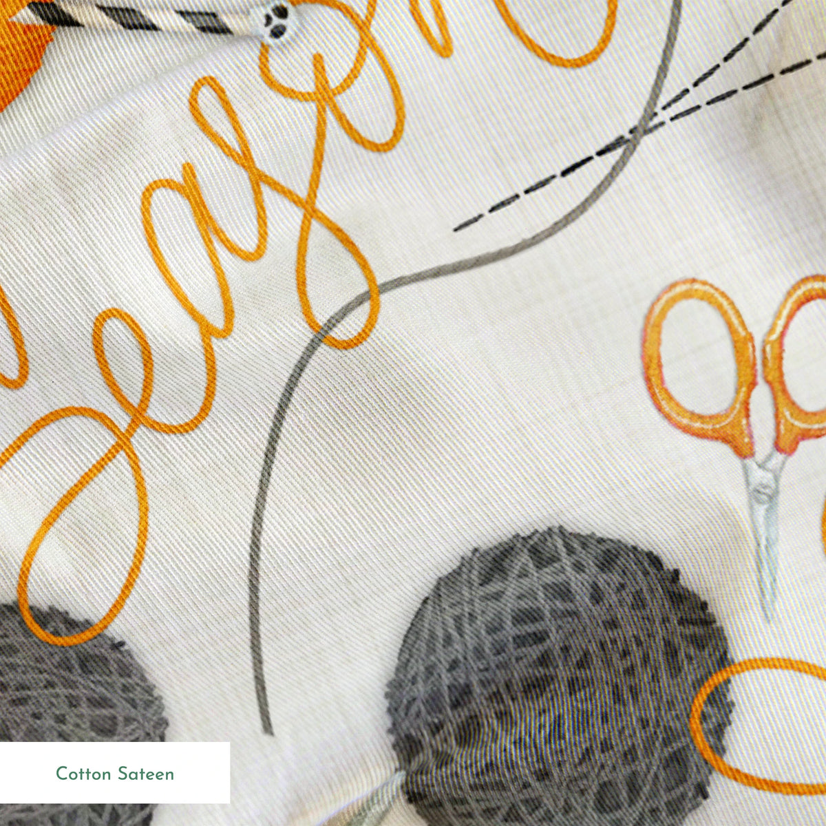 Halloween design by Nicole Tamarin featuring orange and gray yarn balls, scissors, spiderwebs, and “Spooky Season” lettering on a cream background. springs sateen texture