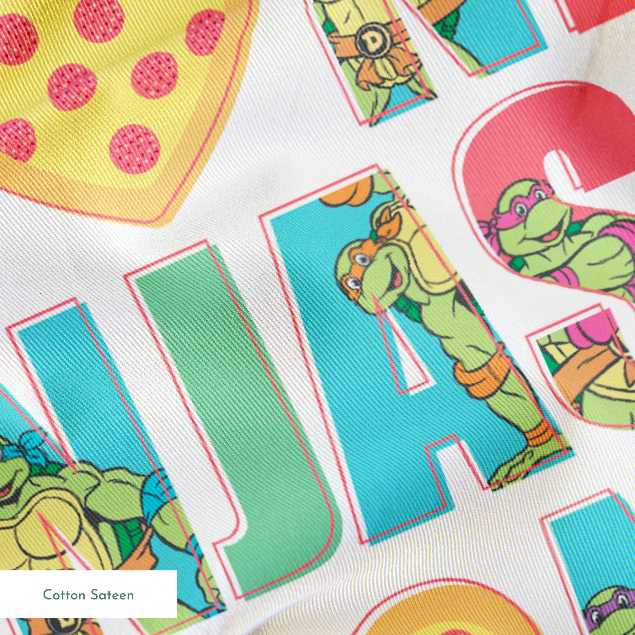 Teenage Mutant Ninja Turtles design with “I heart Ninjas” text with a pizza heart graphic, and Michelangelo and Leonardo in pastel colors. springs sateen texture