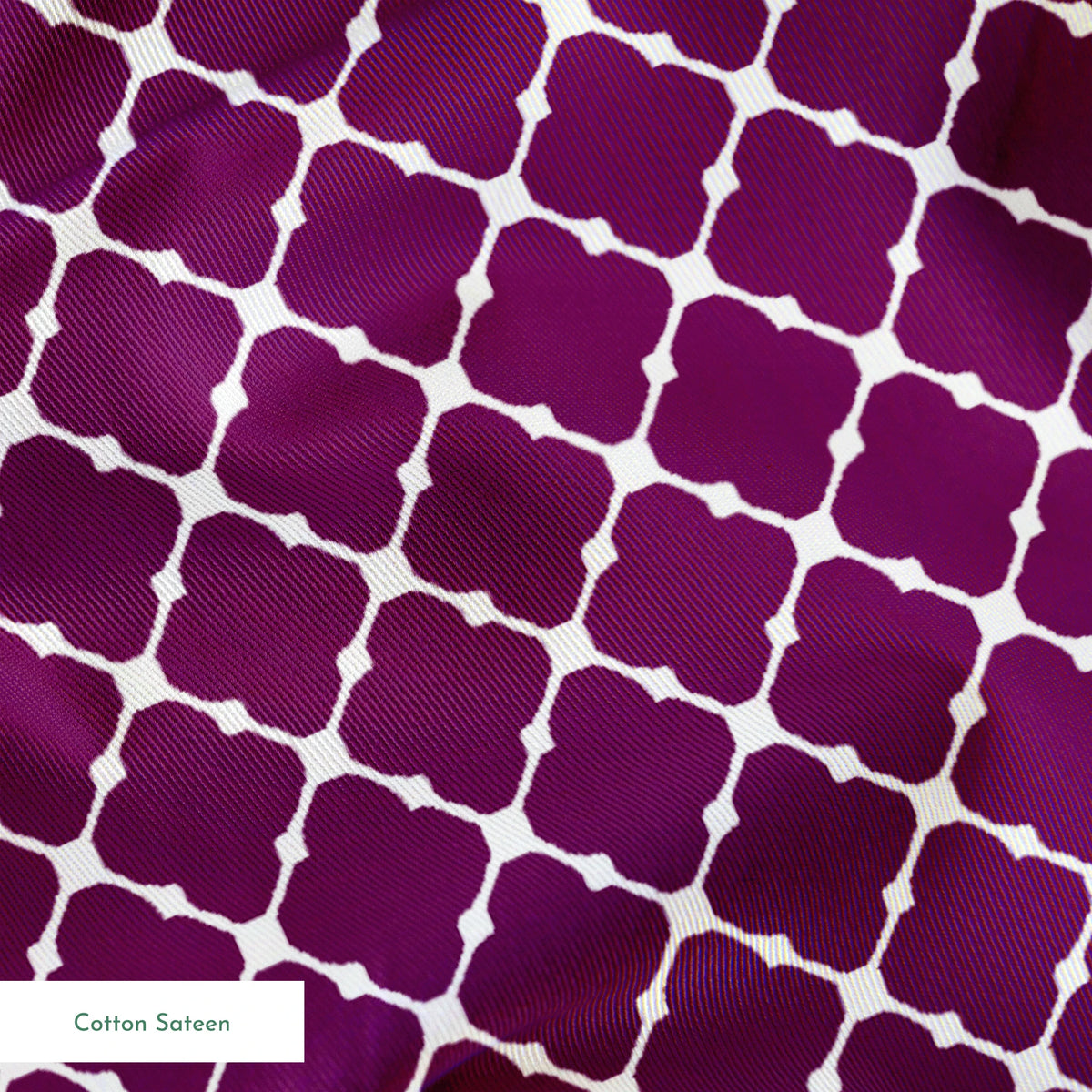 Plum quatrefoil pattern with white lattice outline on deep plum background springs sateen texture