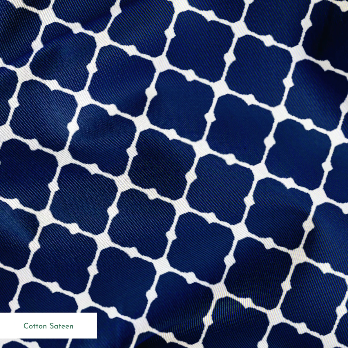 Navy blue quatrefoil pattern with white lattice design on dark background springs sateen texture