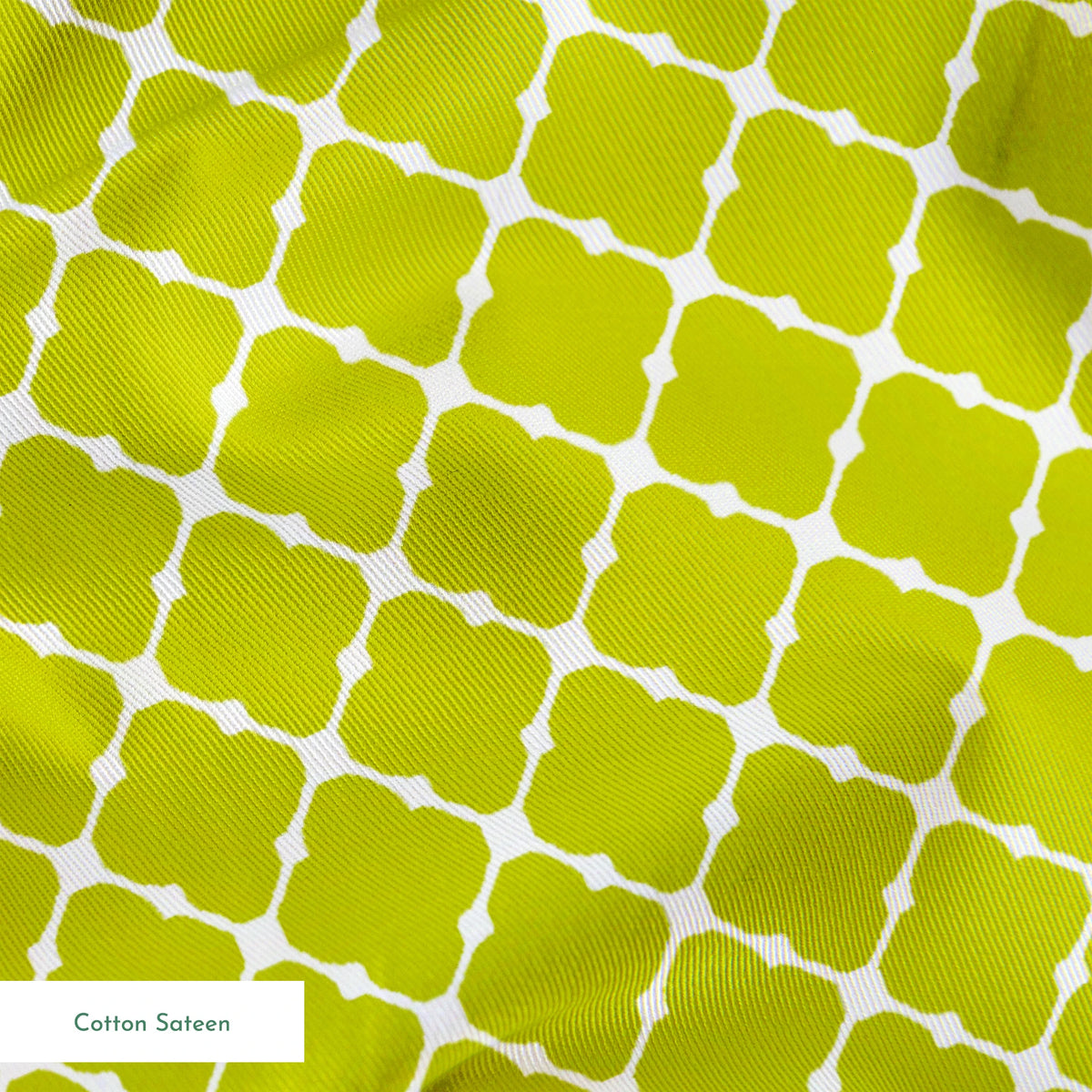 Chartreuse green quatrefoil pattern on white background, forming a geometric lattice design springs sateen texture