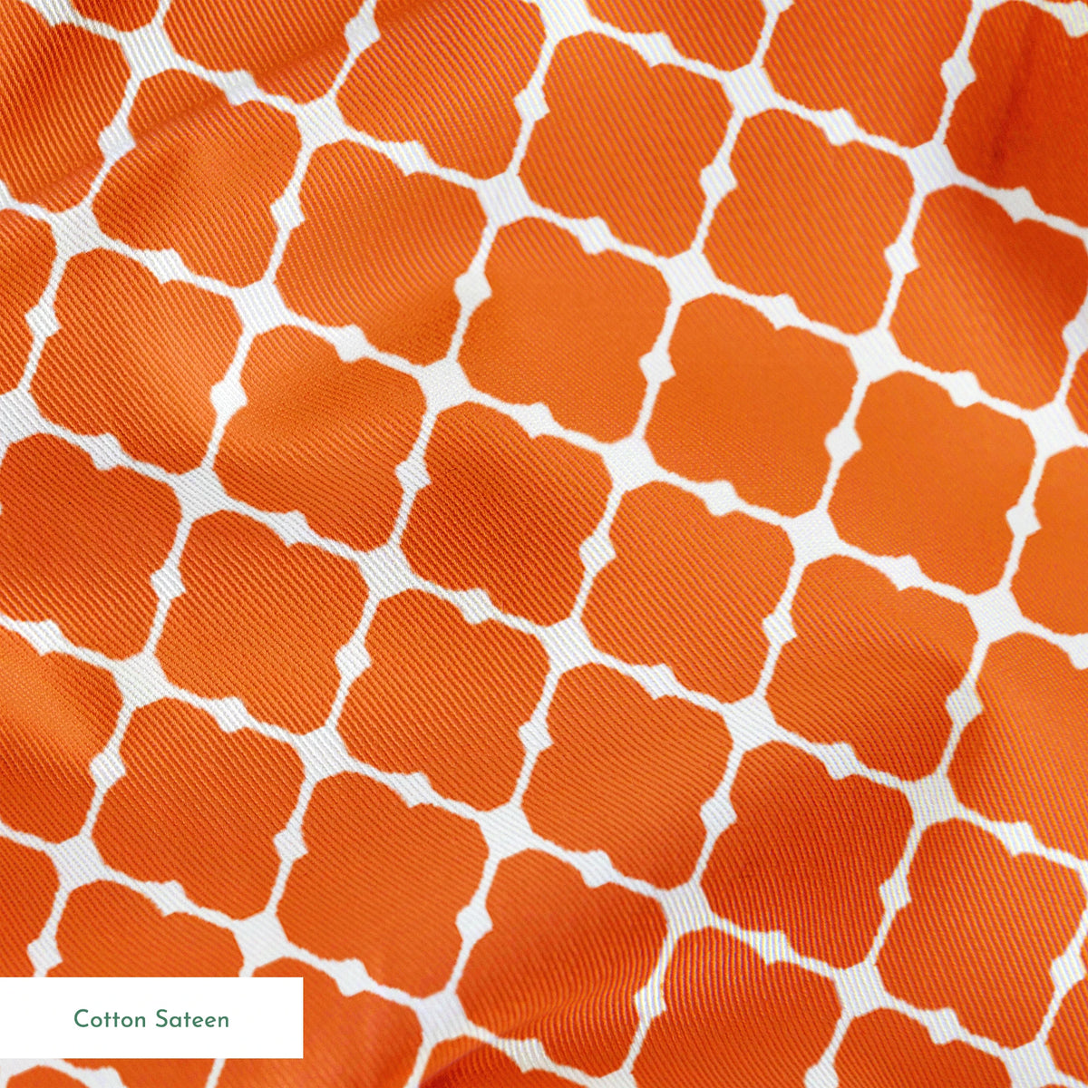Burnt Orange and white quatrefoil pattern with smooth lattice design on orange background springs sateen texture
