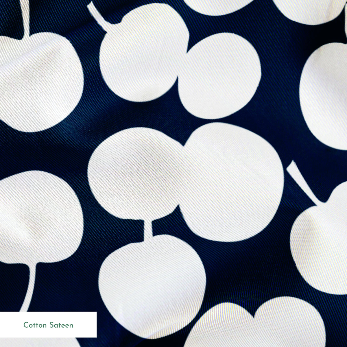 White cherry silhouettes scattered across a deep navy blue background in a playful pattern springs sateen texture