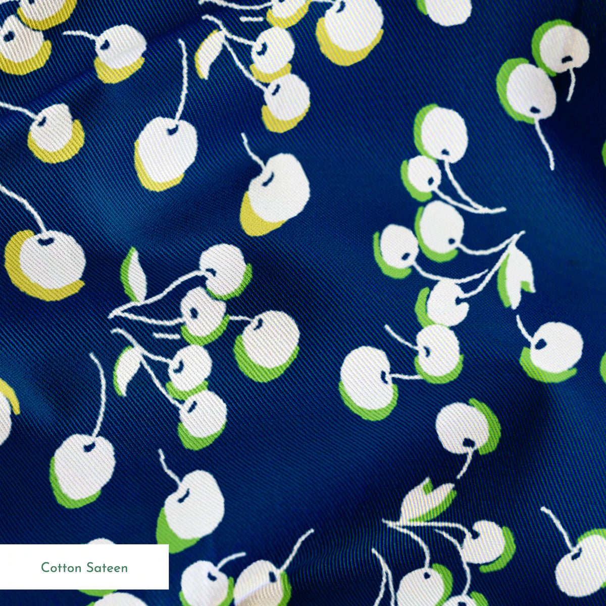 Delicate white and yellow floral pattern scattered across a deep navy blue background springs sateen texture