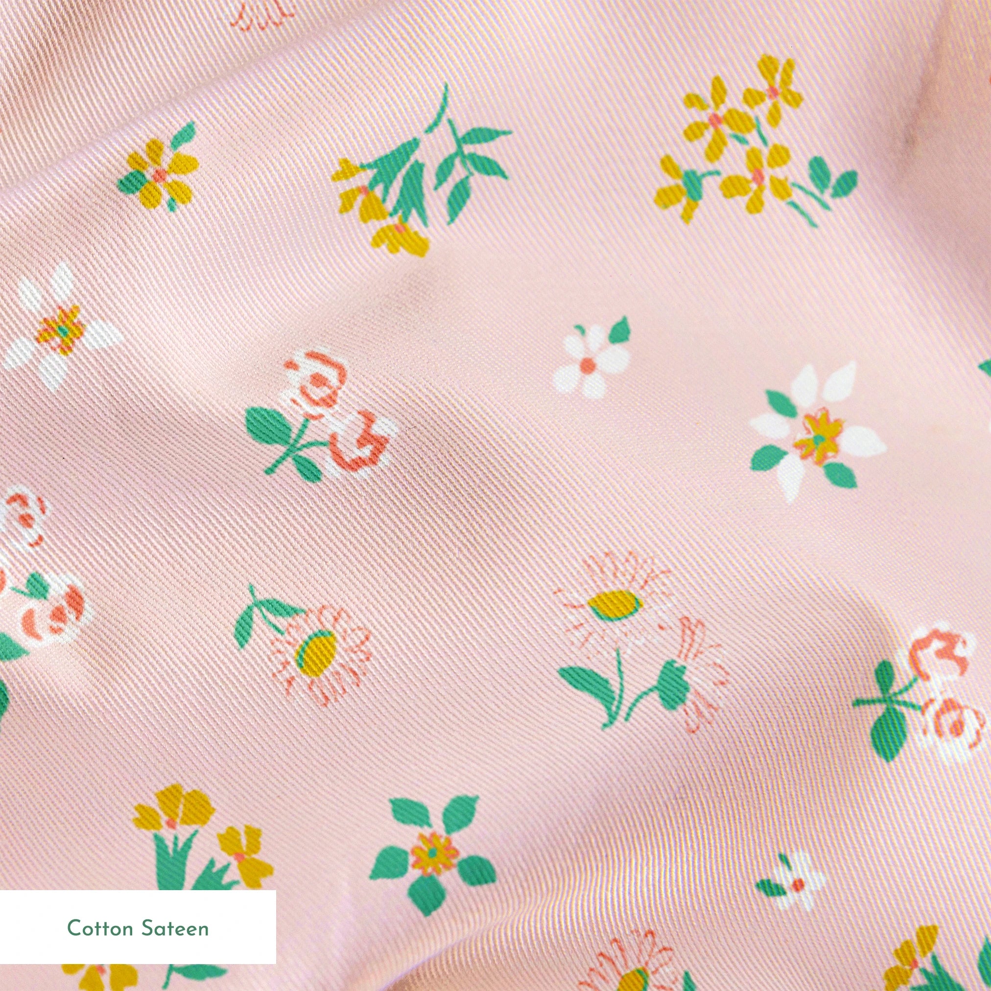 Small floral pattern on pink background with white daisies and yellow, blue, and pink flowers springs sateen texture