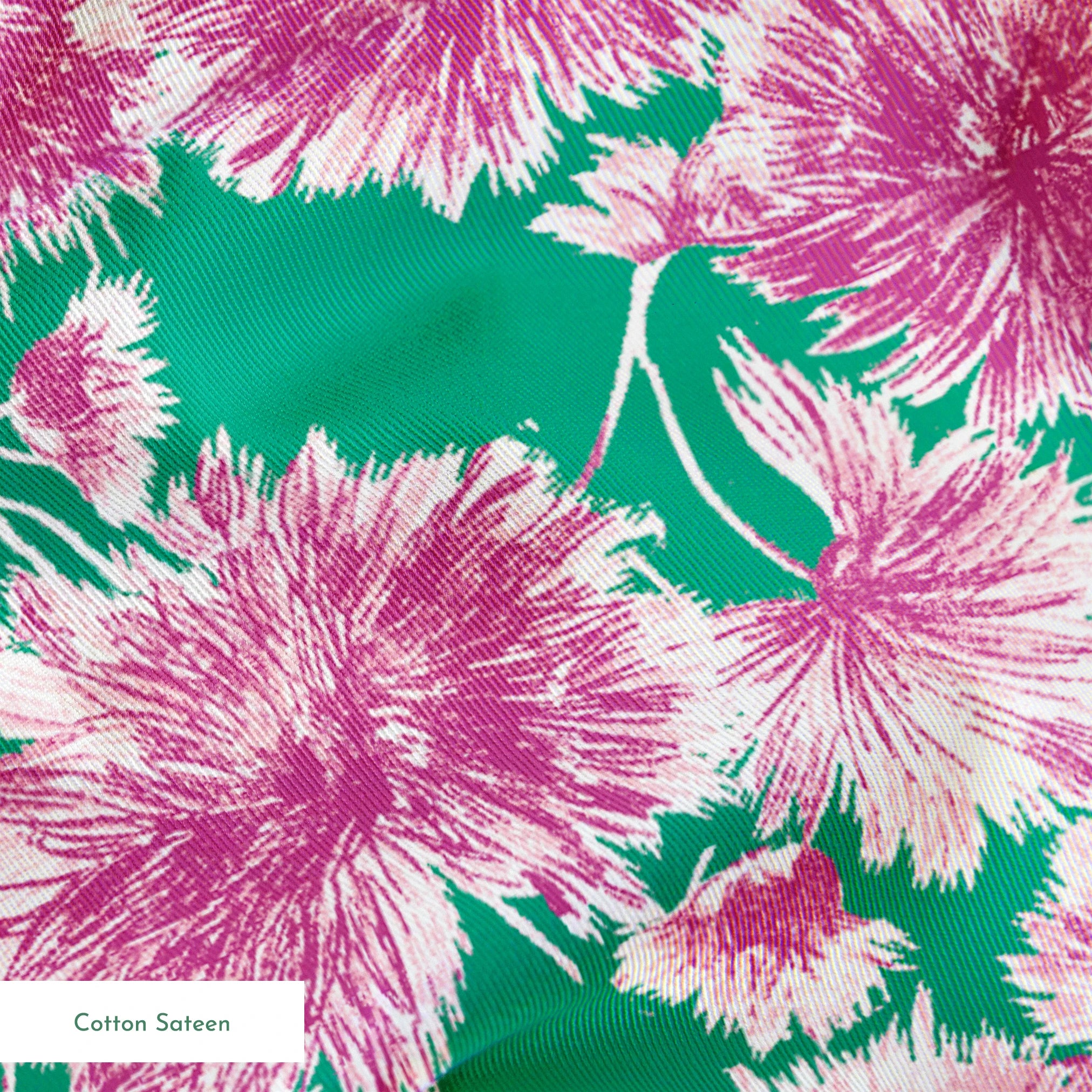 Pink and purple carnation flowers scattered on a green background in a repeating floral pattern springs sateen texture
