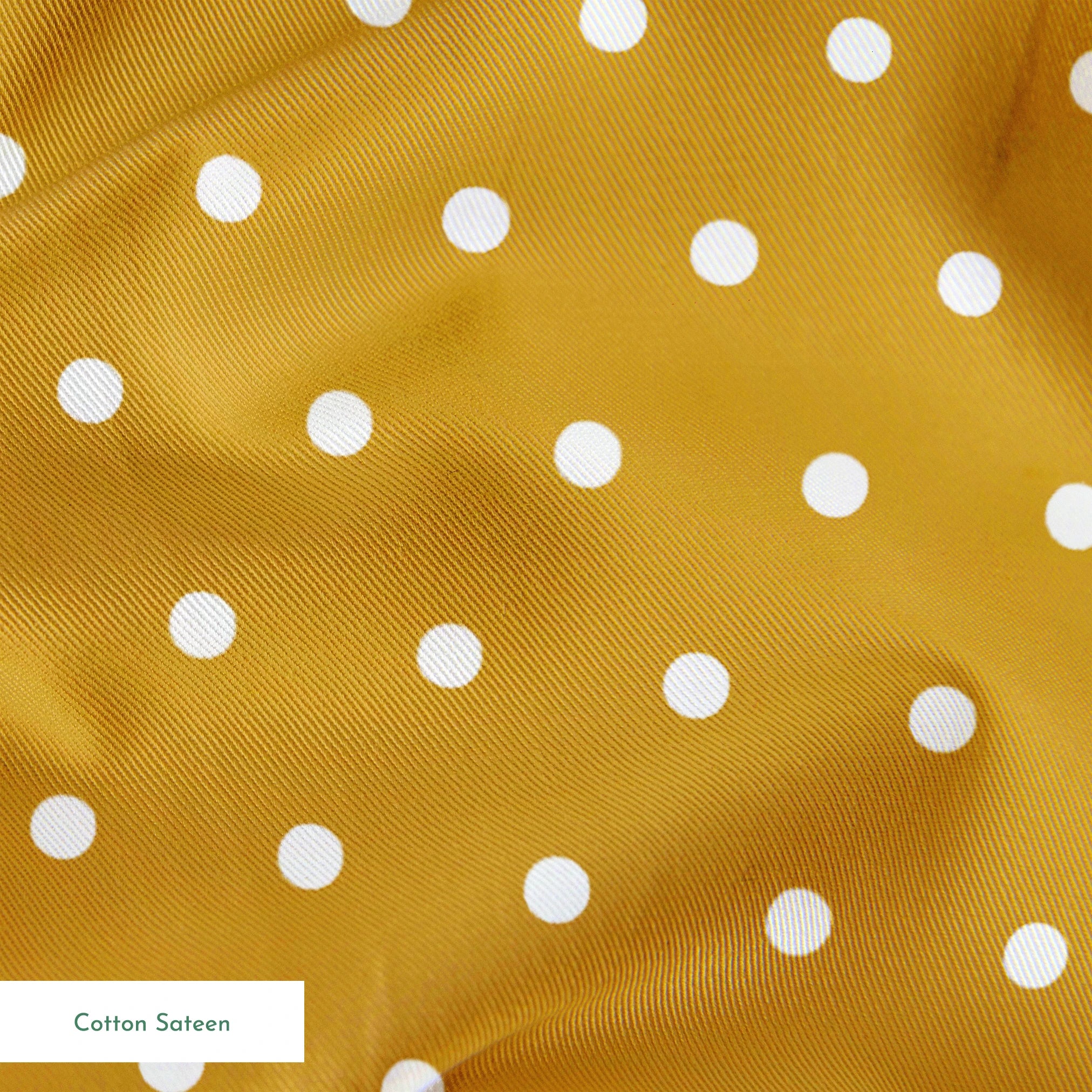 White circles on a golden yellow background springs sateen texture