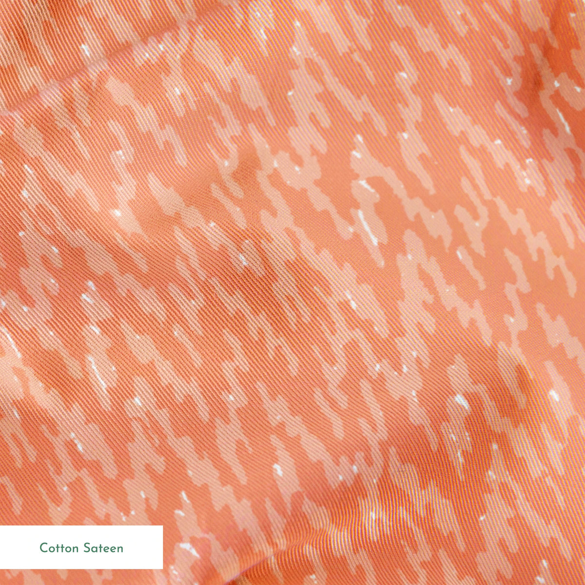 Peachy coral abstract pattern with light brushstroke-like texture and diagonal movement springs sateen texture
