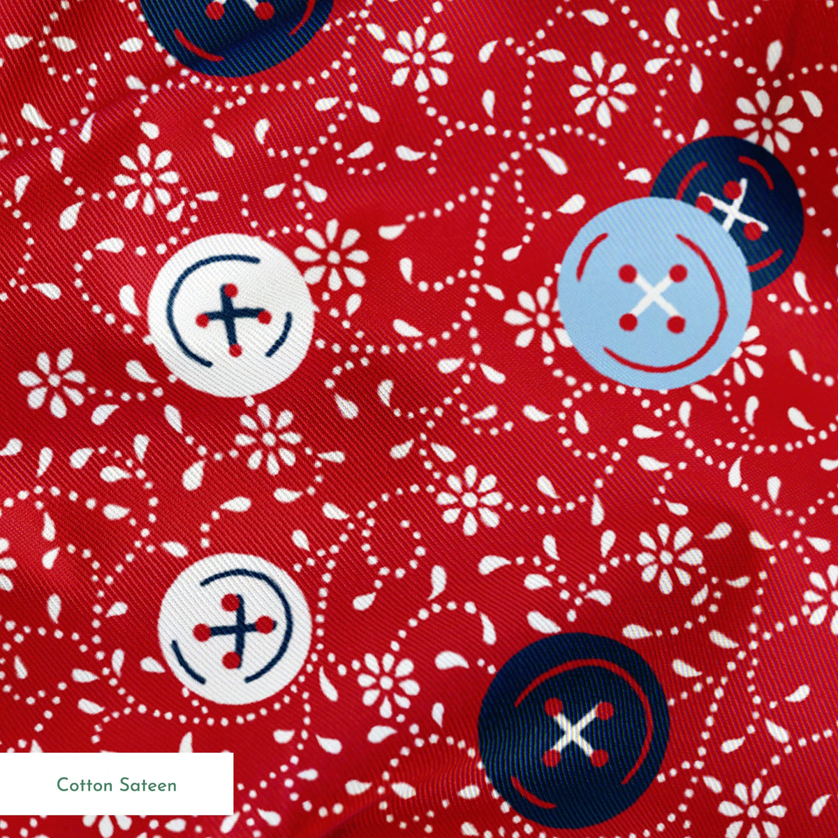 Red background with small white floral pattern featuring scattered button designs in blue, white, and navy cross details springs sateen texture