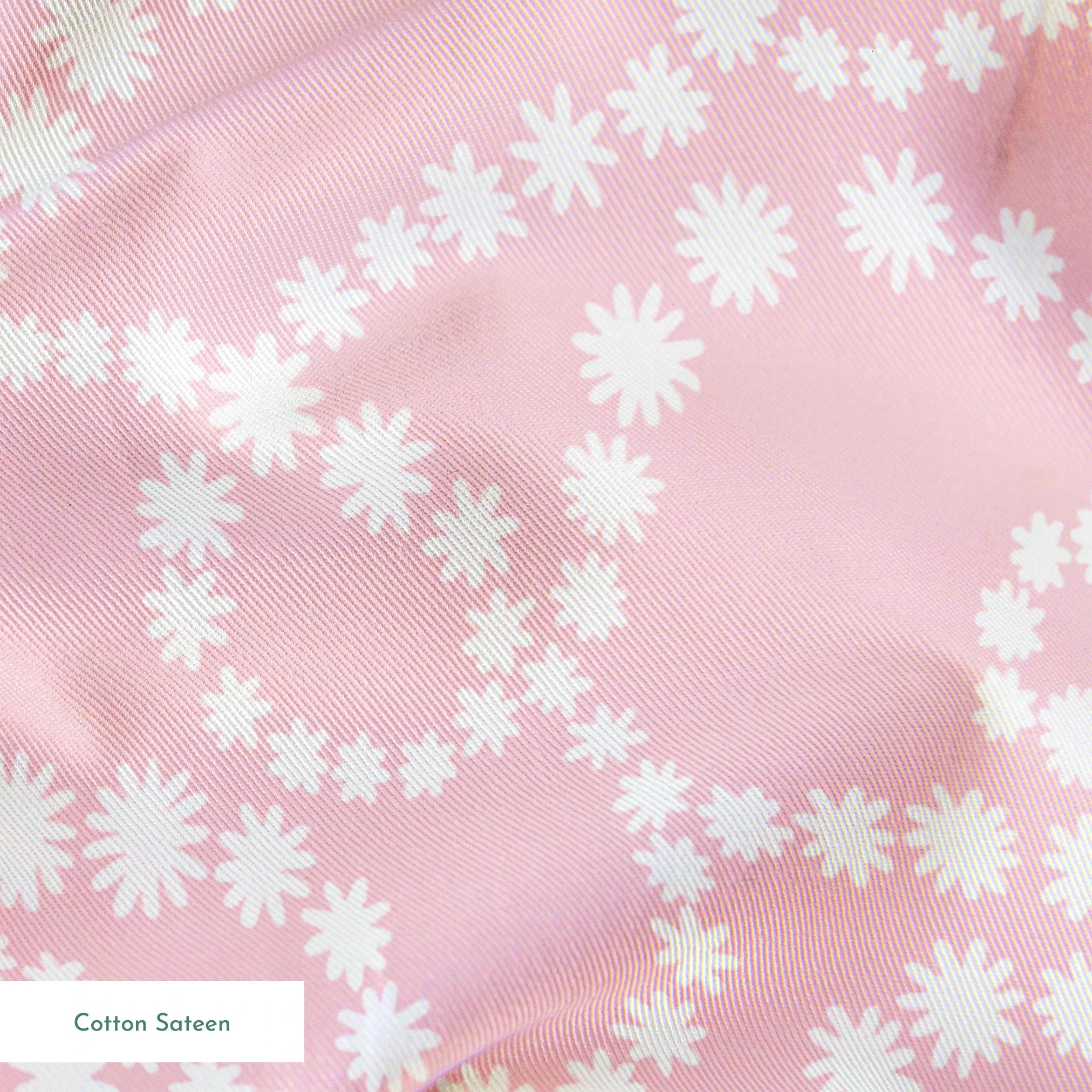 Baby pink background with white dotted swirling pattern creating delicate curved lines and loops springs sateen texture