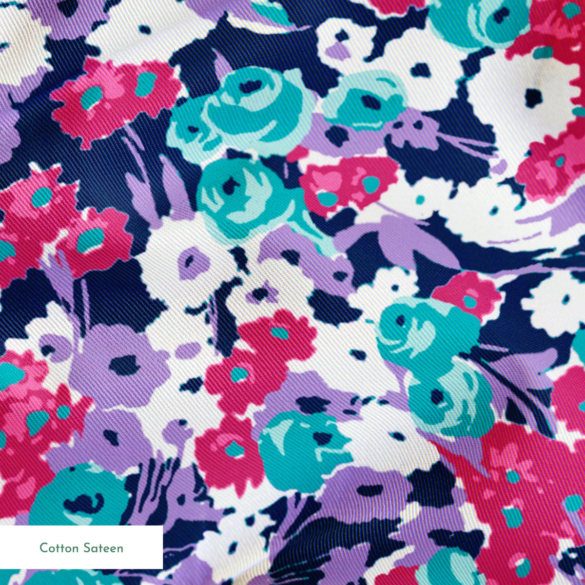 Vibrant floral pattern with pink, white, purple, and turquoise flowers on dark indigo background springs sateen texture