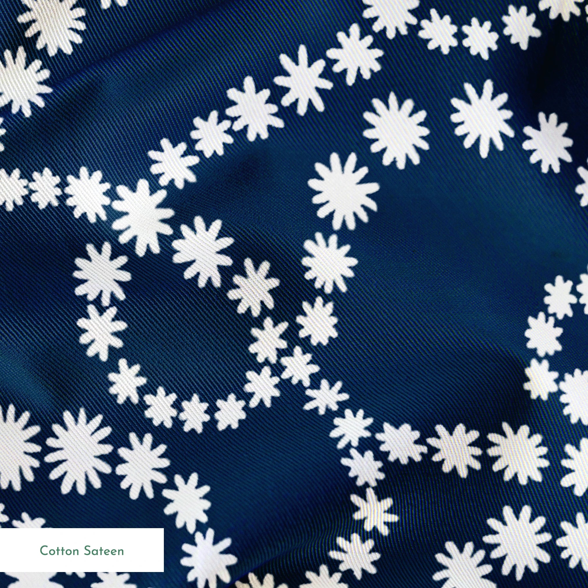 Navy blue background with swirling white dotted patterns creating circular and flowing designs springs sateen texture