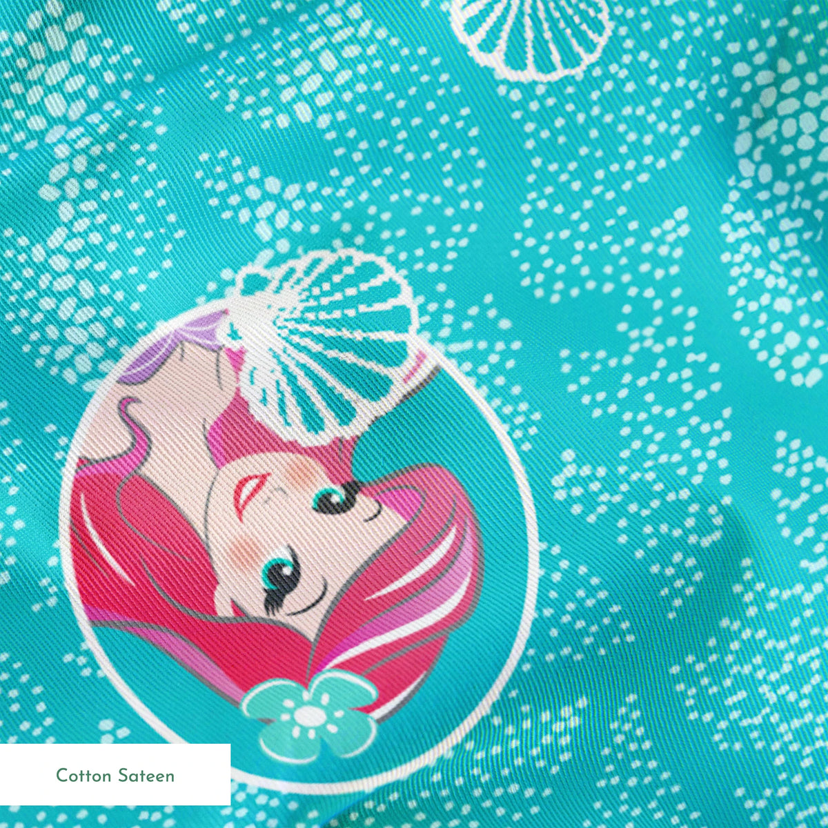 The Little Mermaid pattern with Ariel in turquoise circles on aqua background with seashells springs sateen texture
